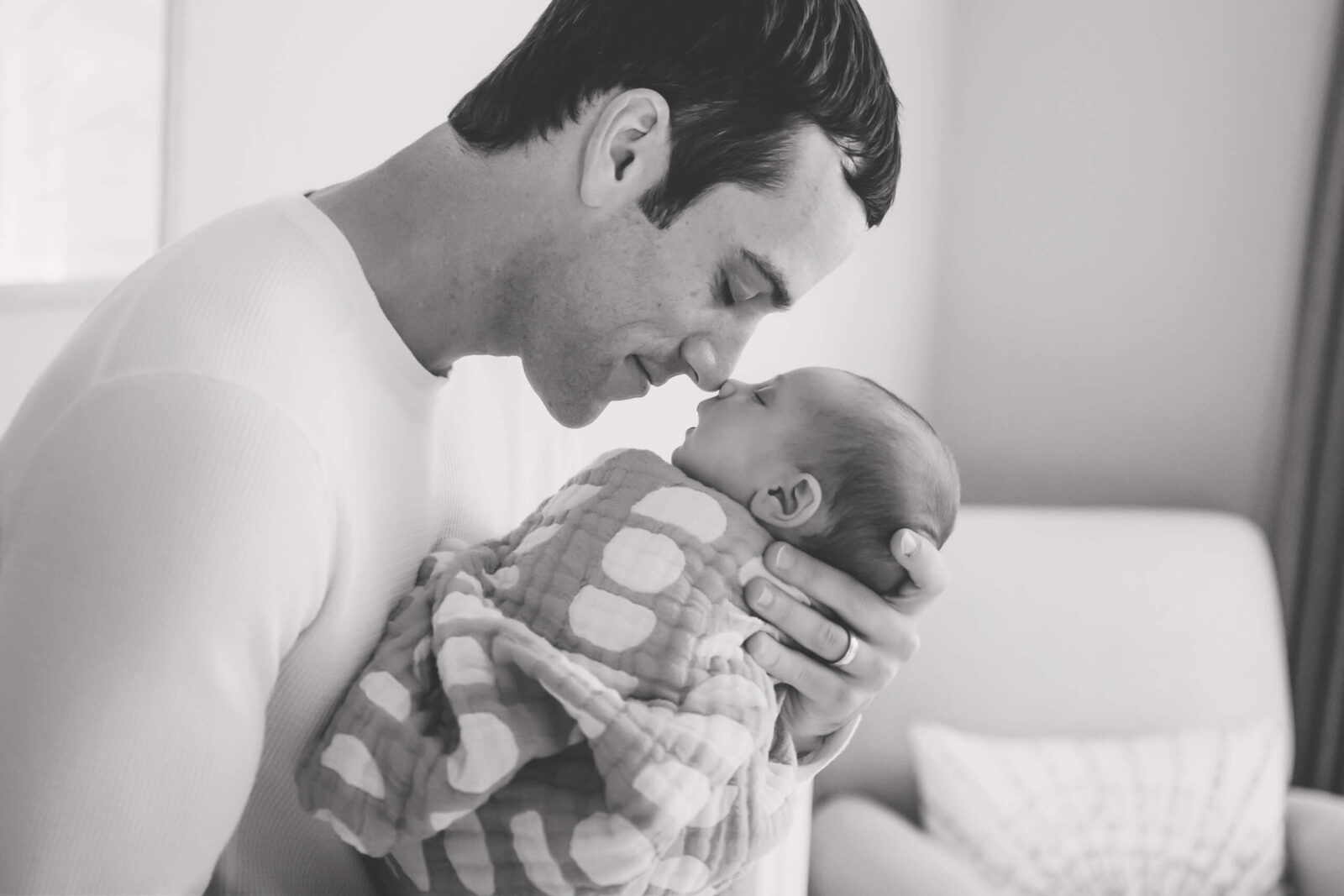 Seattle in-home newborn photo shoot, dad holding his baby close to his face, noses touching
