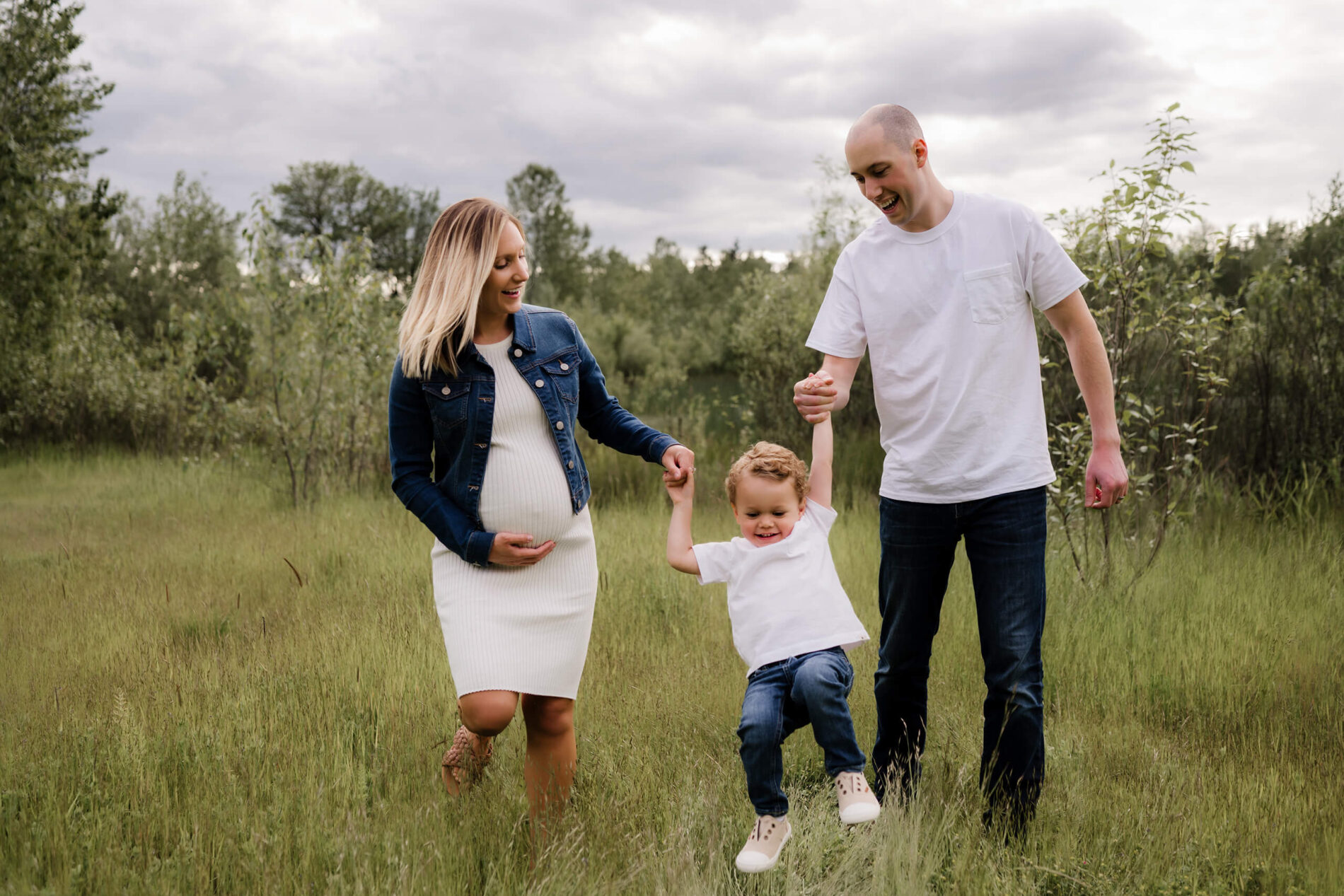 Pregnancy photo shoot in Bellevue, mom and dad playing with their toddler