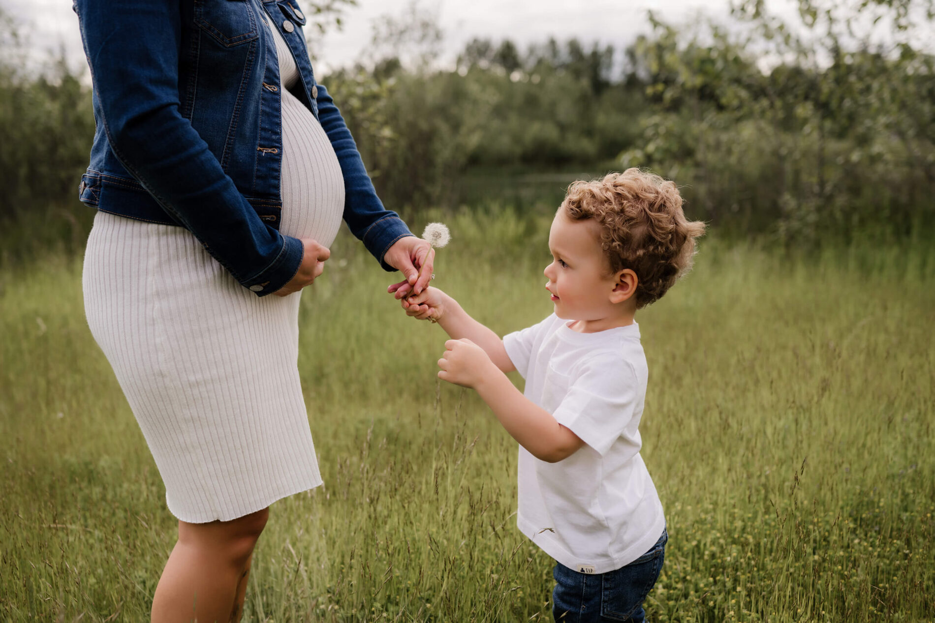 Redmond maternity photography, pregnant woman playing with her toddler in a field