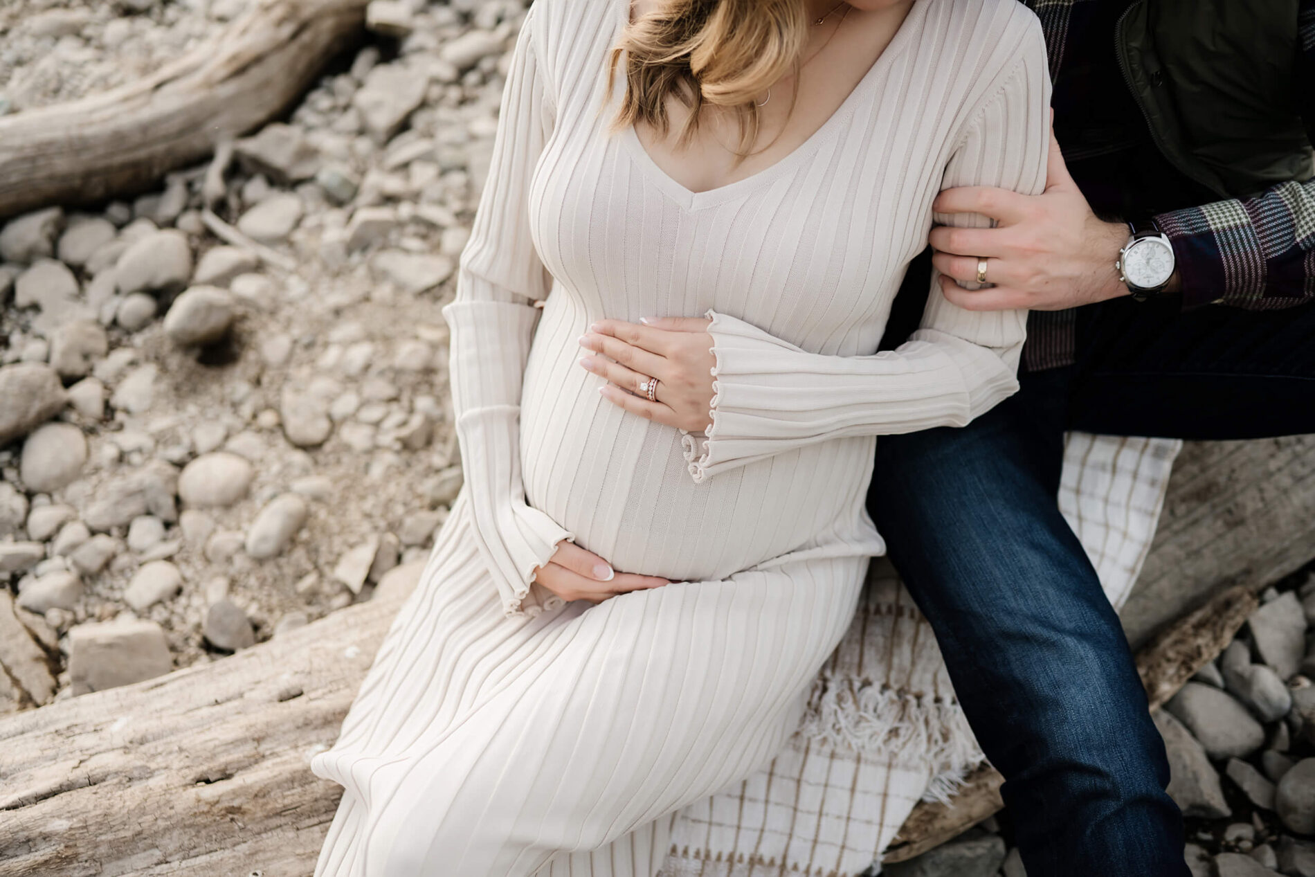 Maternity photo of a couple with a focus on the belly