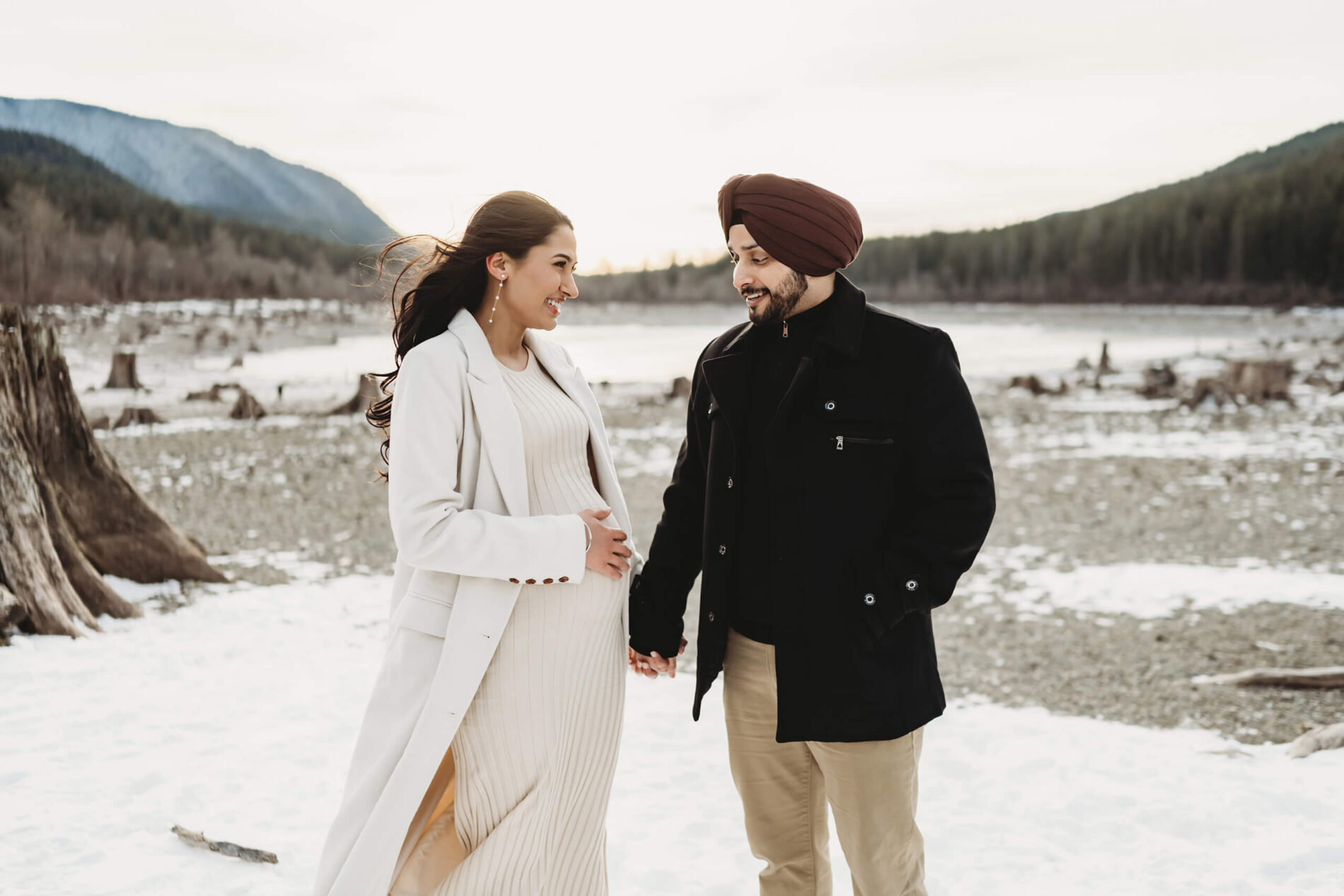 A couple holding hands during pregnancy photo shoot in Seattle