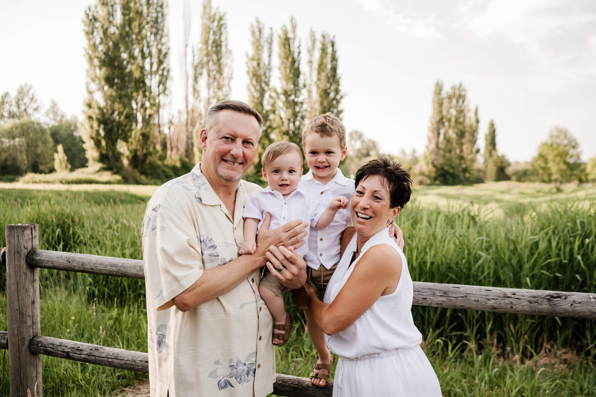 Bellevue area natural family photoshoot with grandparents, grandpa and grandma posing with two grandsons