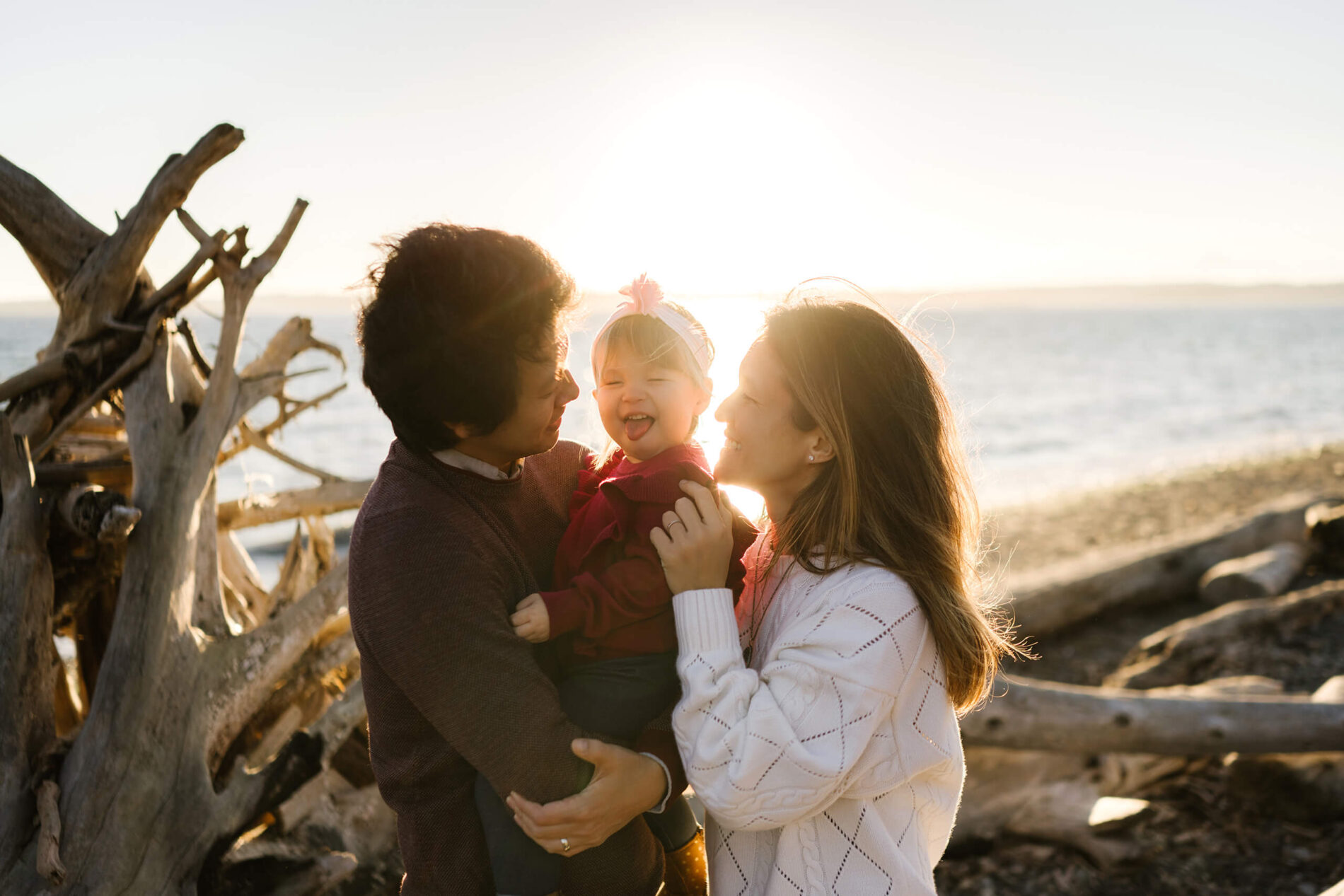 Family playing during a photo shoot on a beach in Seattle