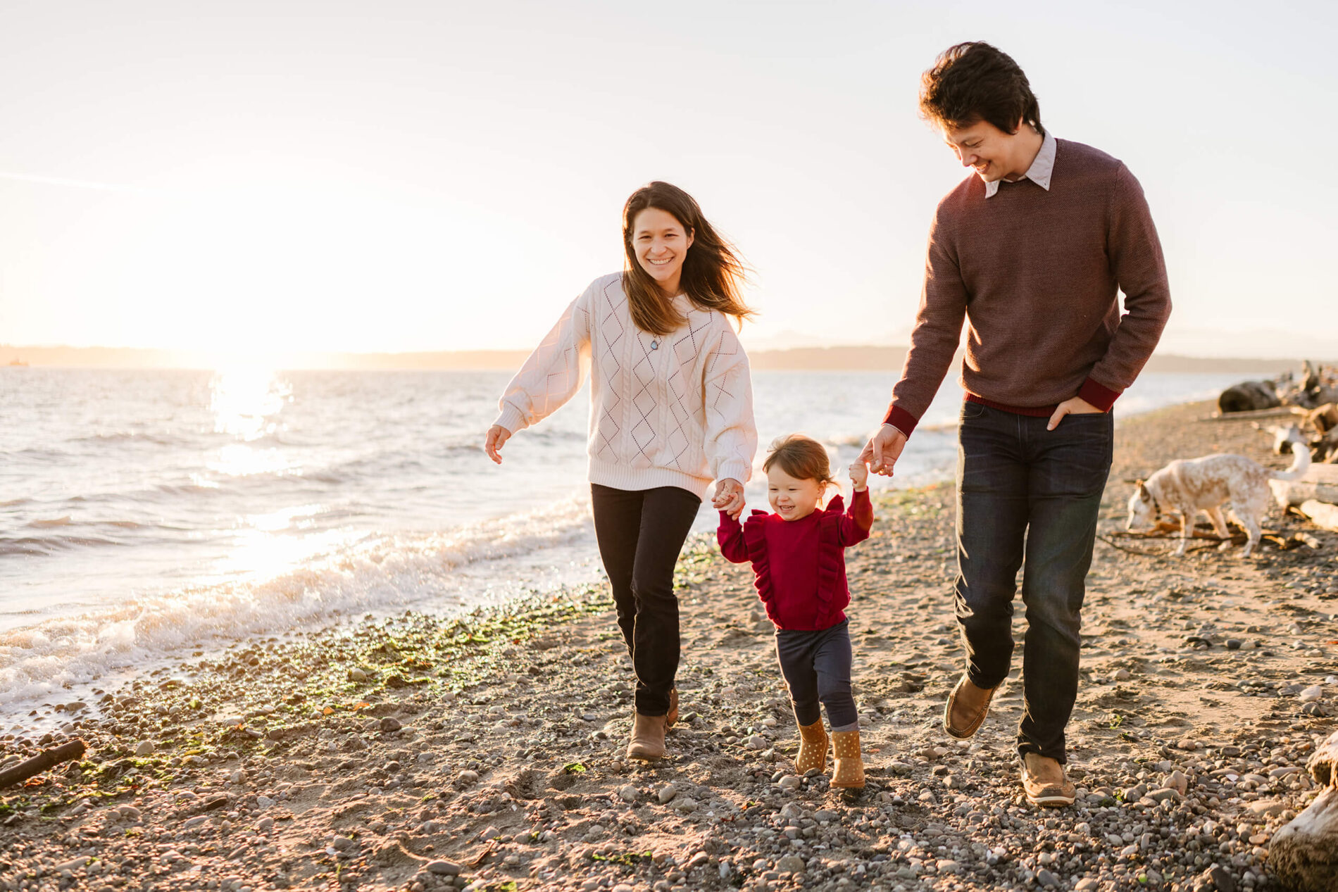 Family playing during a photo shoot on a beach in Seattle