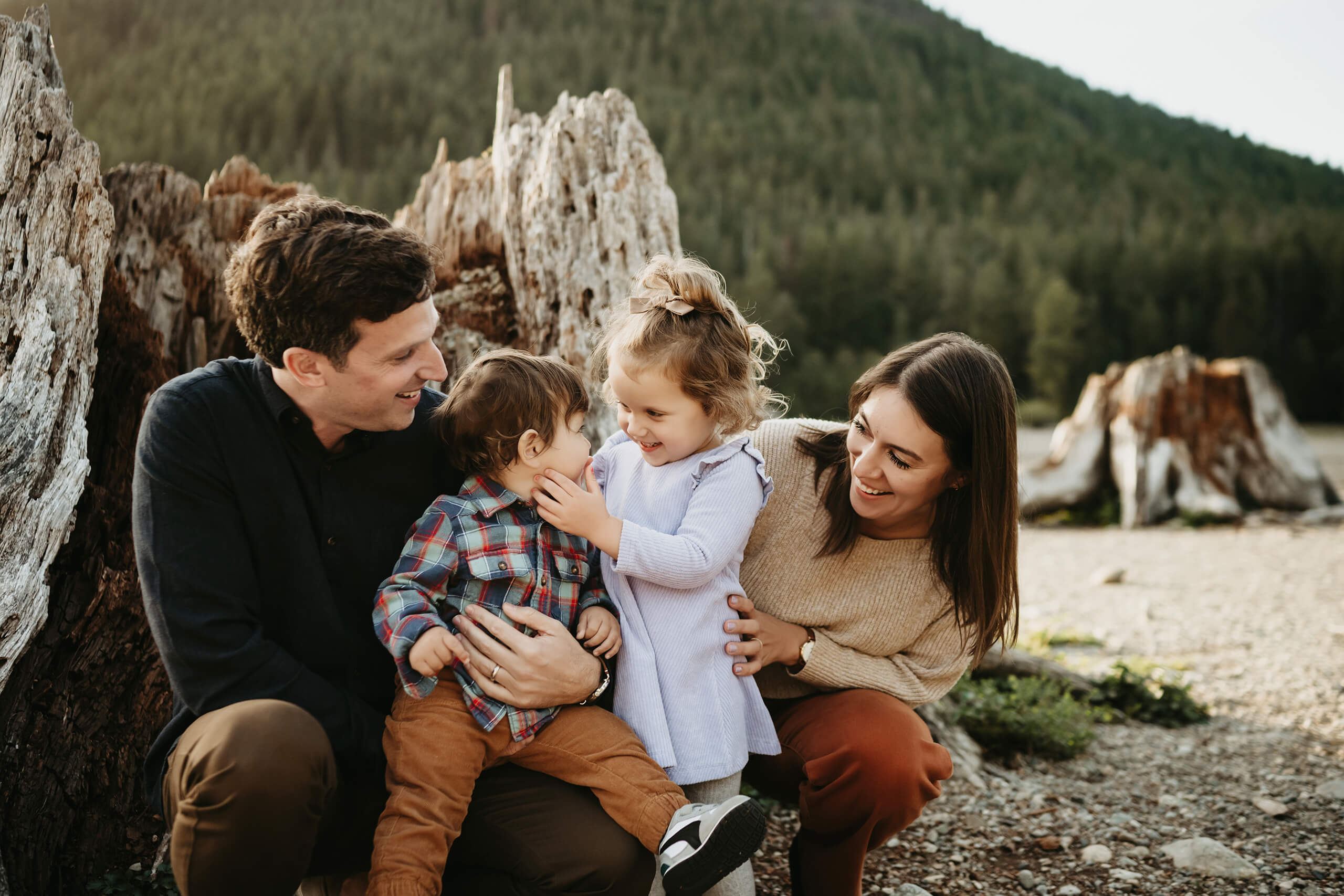 Seattle family photos, dad, mom, and two toddlers having fun during a photo shoot with Cascades in the background