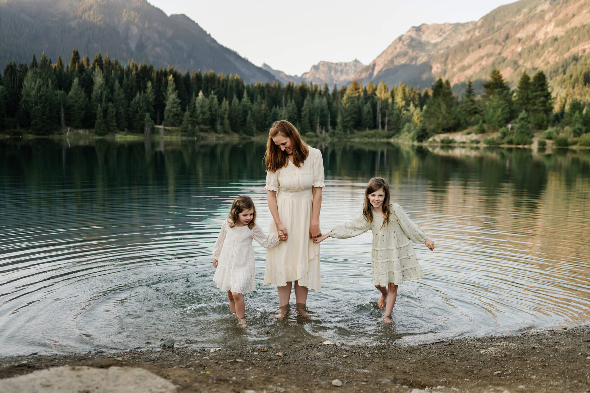 Seattle family photography, mom with two daughter standing in a pond at Snoqualmie Pass