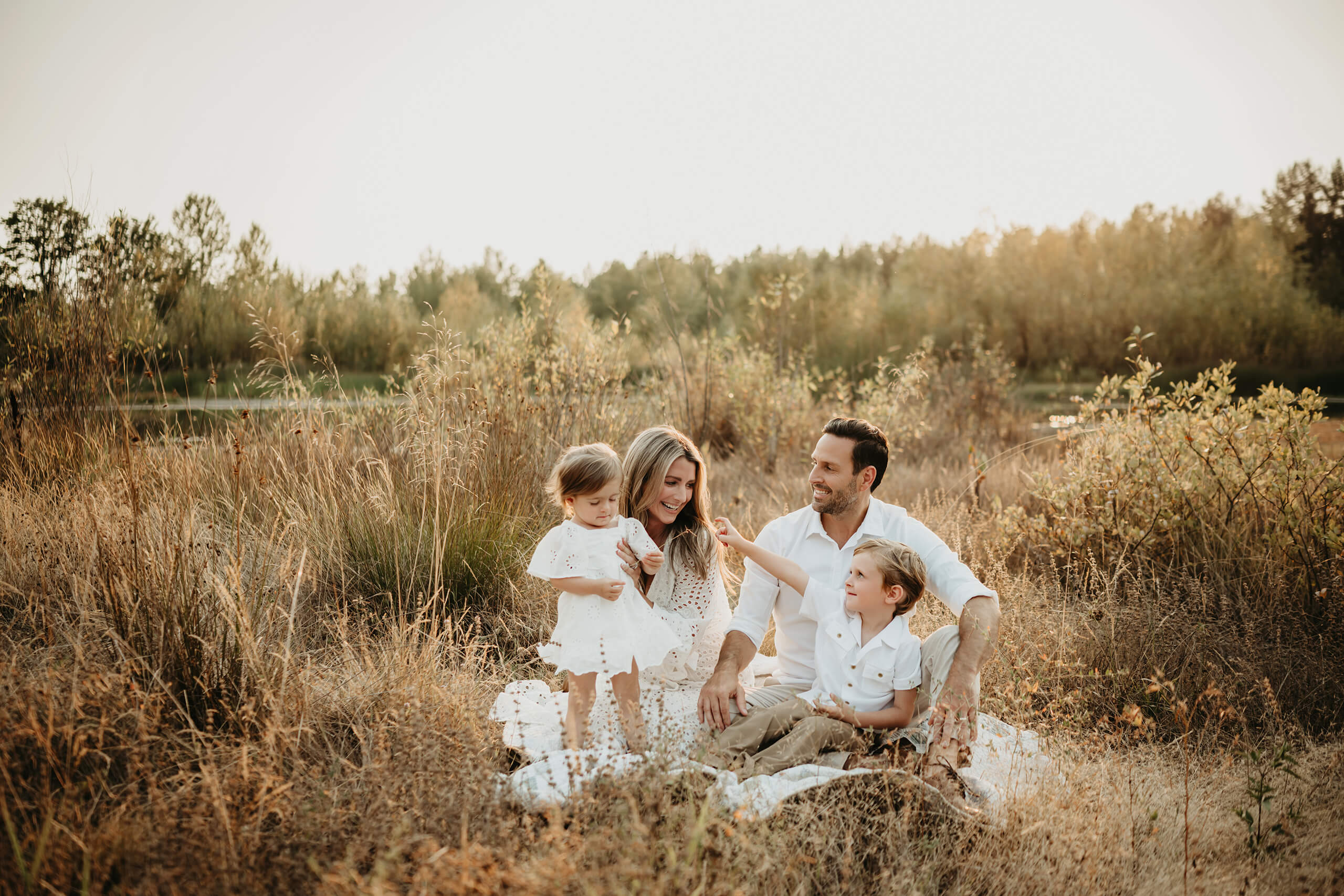 Seattle family photography, a moment during family photo session, young dad and mom playing with two kids