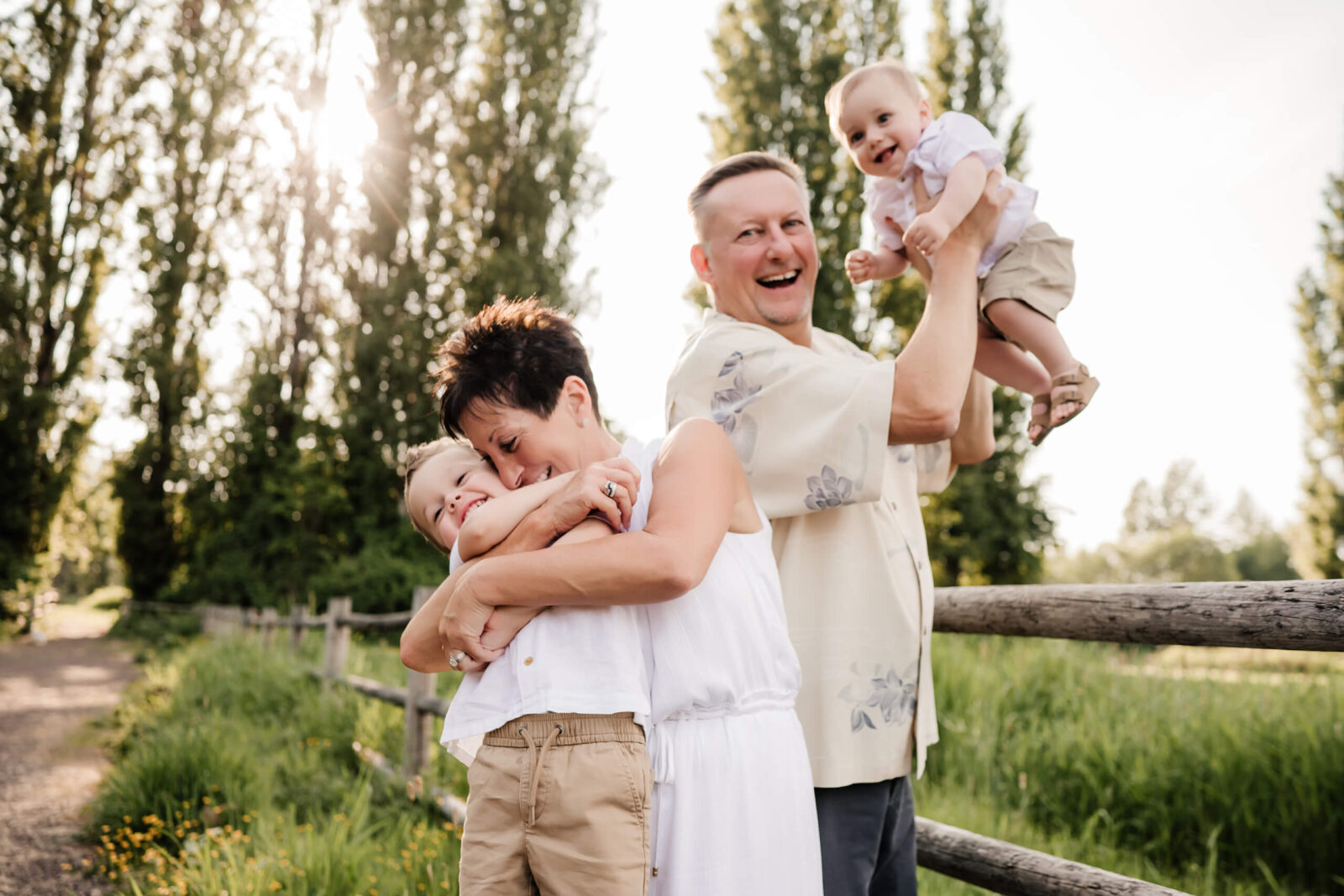 Bellevue family photography with grandparents, grandpa and grandma playing with two grandsons