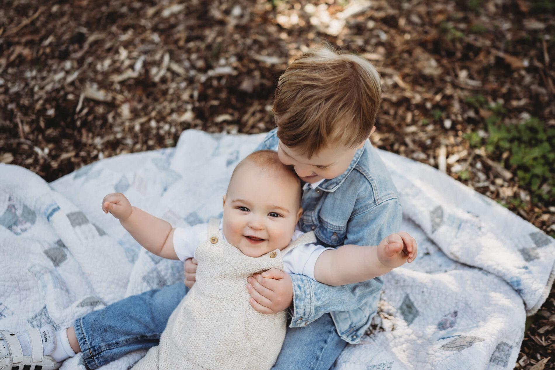 Fun family photo of two smiling siblings during spring at Washington Park Arboretum