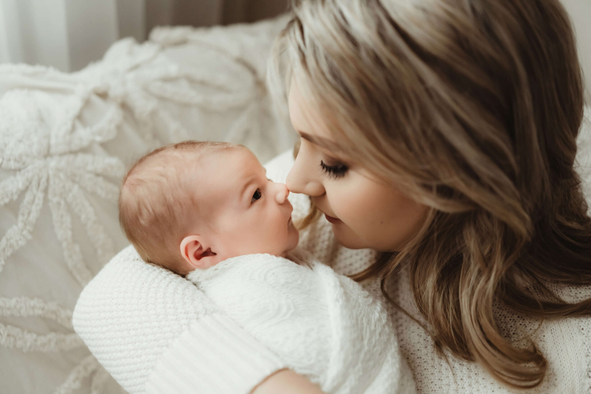 Moving newborn photo capturing the bond between mom and her baby, moment during newborn photo shoot in Kirkland WA