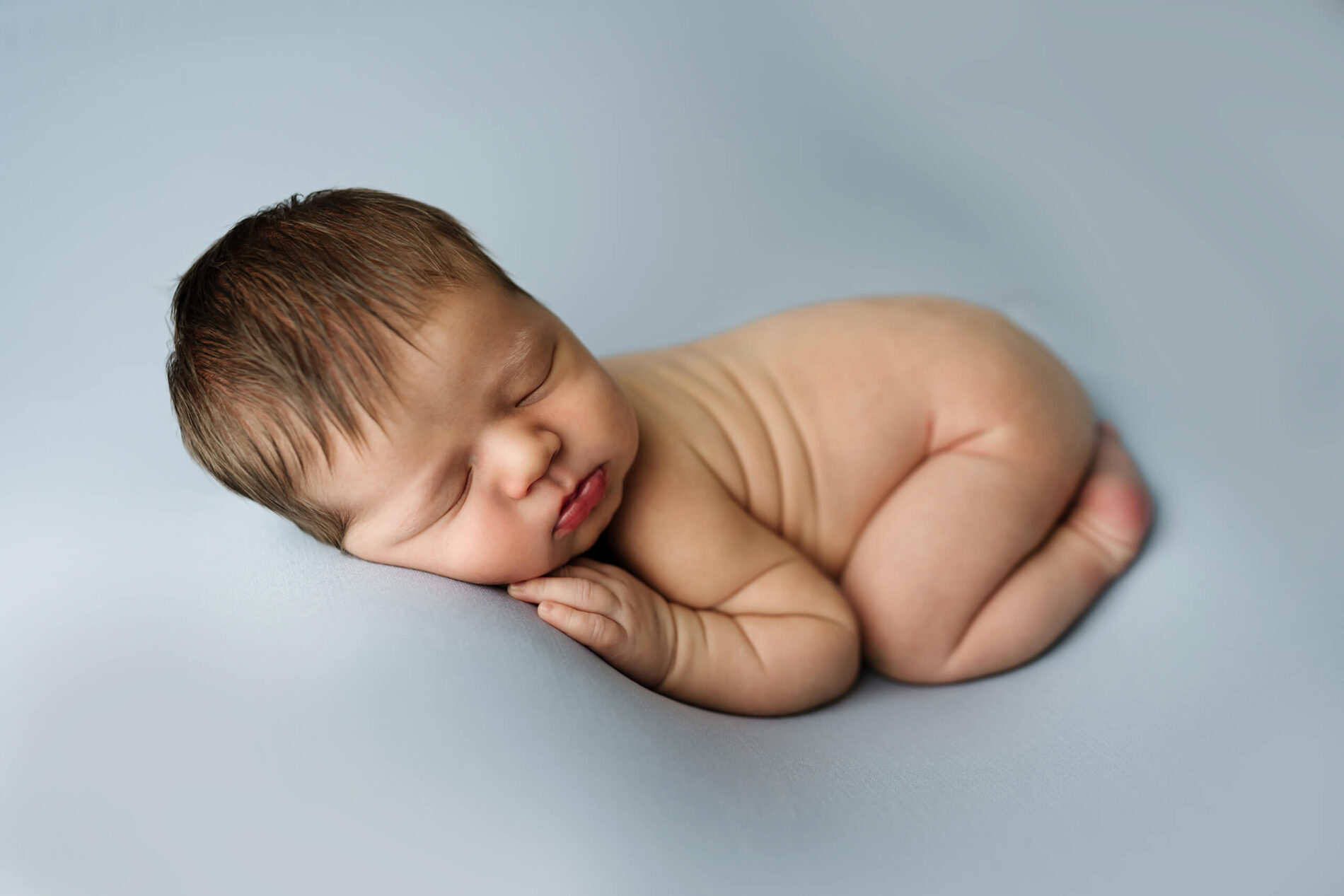 Baby photography in Bellevue. Posed infant boy in a photography studio.