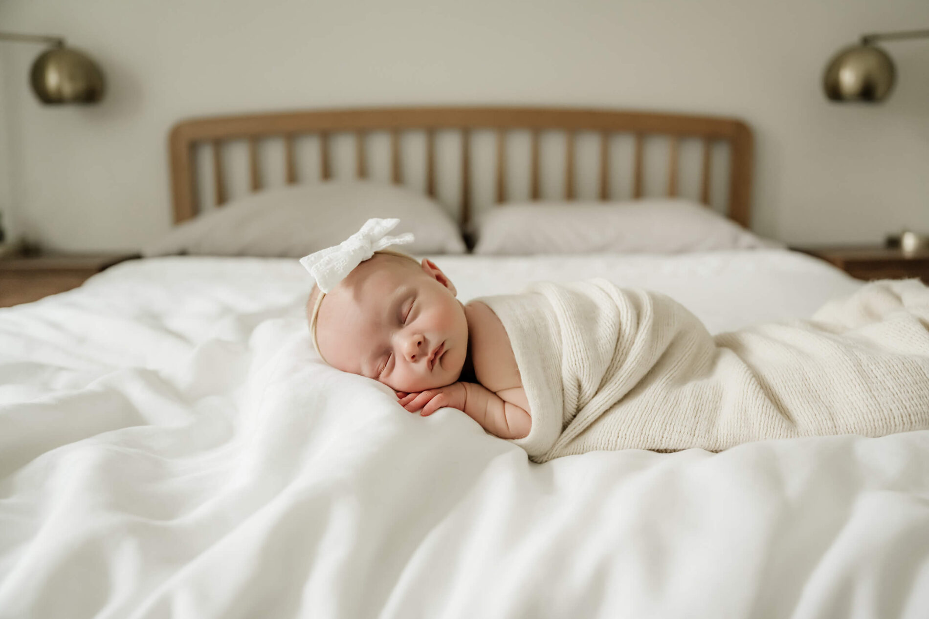 An idea for in home newborn photography in Kirkland WA. Infant girl posed on parents bed.