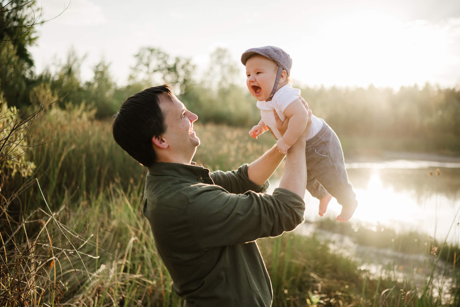 Dad playing with his baby son during a family photoshoot in Redmond, WA