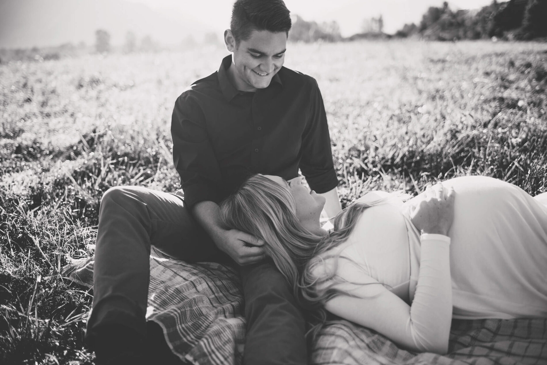 A connected pregnant couple in an open field during maternity photoshoot in North Bend WA