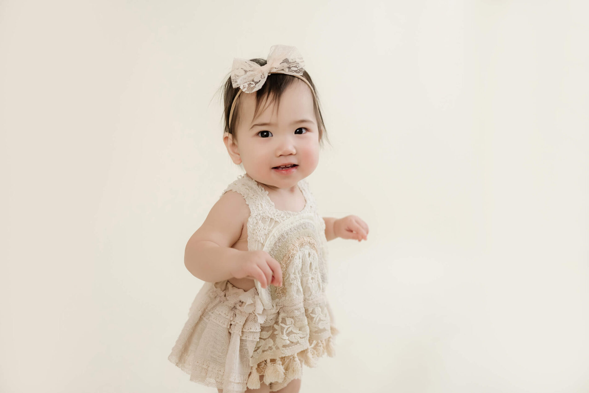 1st year milestone portrait session in Seattle, cute smiling 1-year old girl posing for a photo