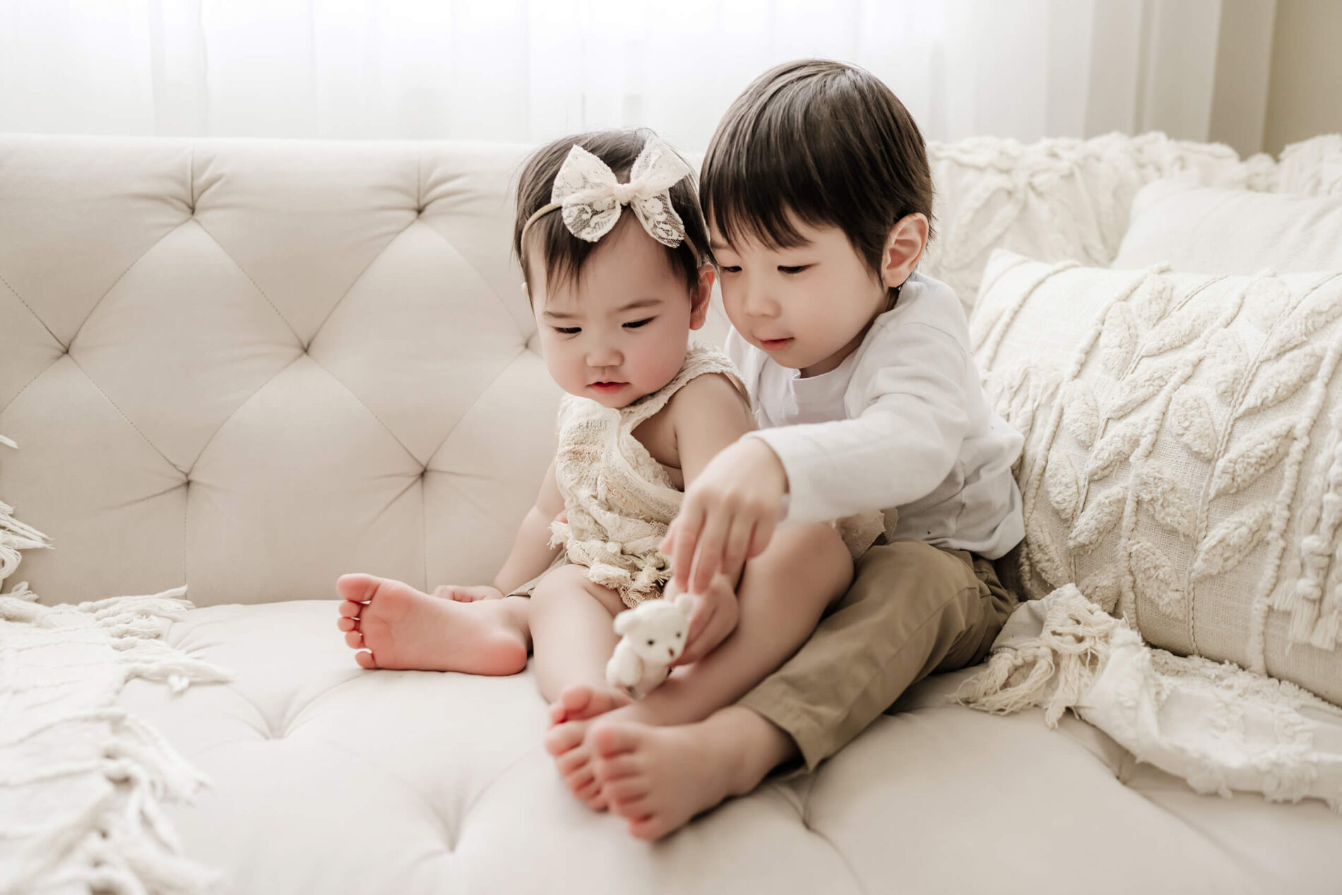 Seattle baby milestone session, siblings playing during a photo sessoin