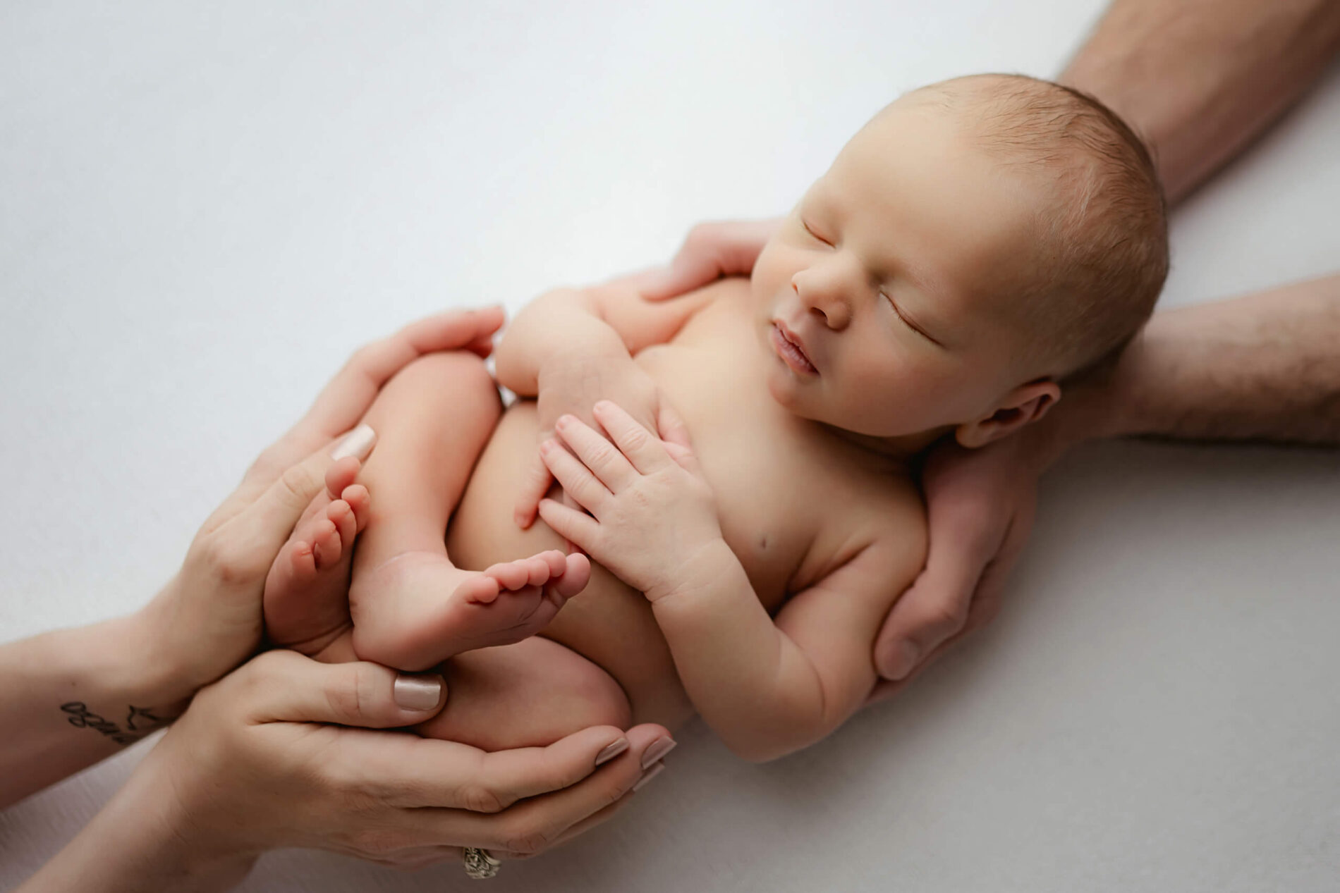 Unique posing idea of newborn and parents during a photo session in Seattle
