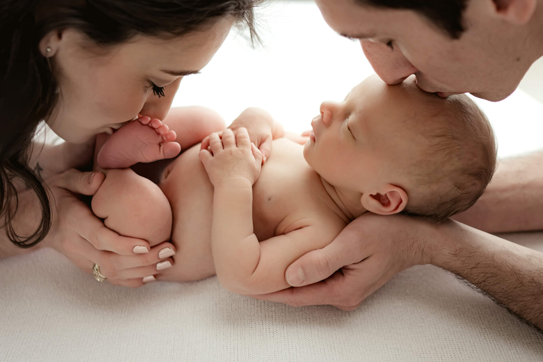 Unique newborn photography with parents in a Seattle studio