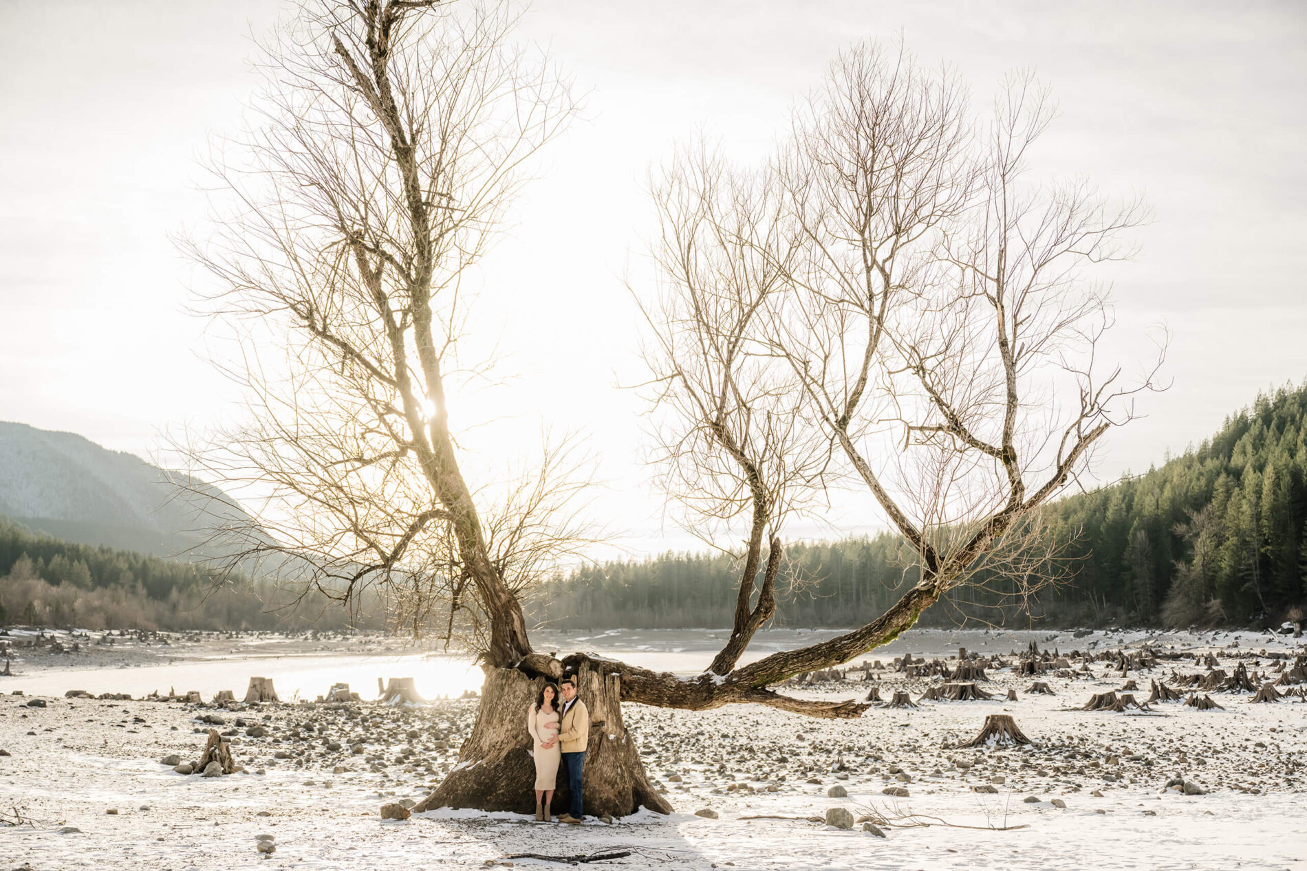 Seattle maternity photography with mountains, trees, and a lake in the background