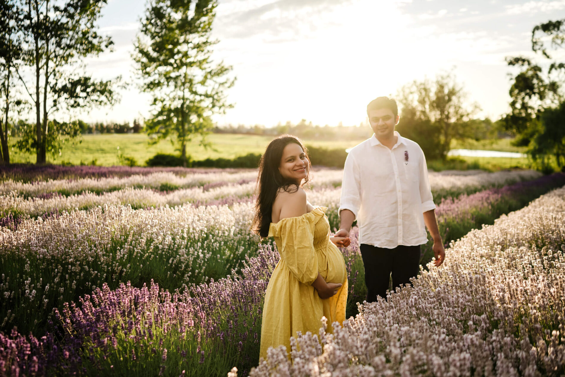 A couple posing during maternity session at a lavender farm in Seattle