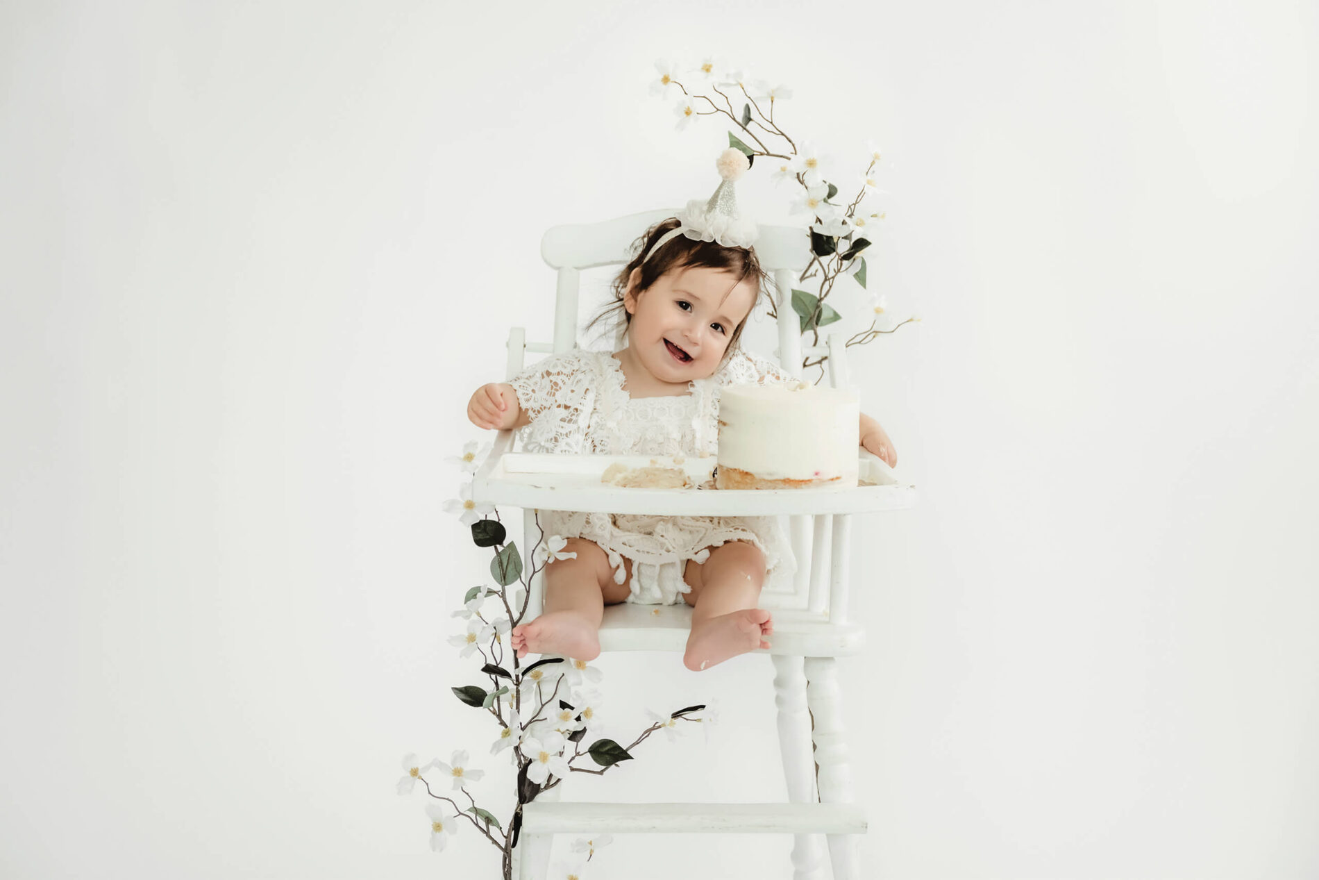Happy toddler smiling during cake smash session