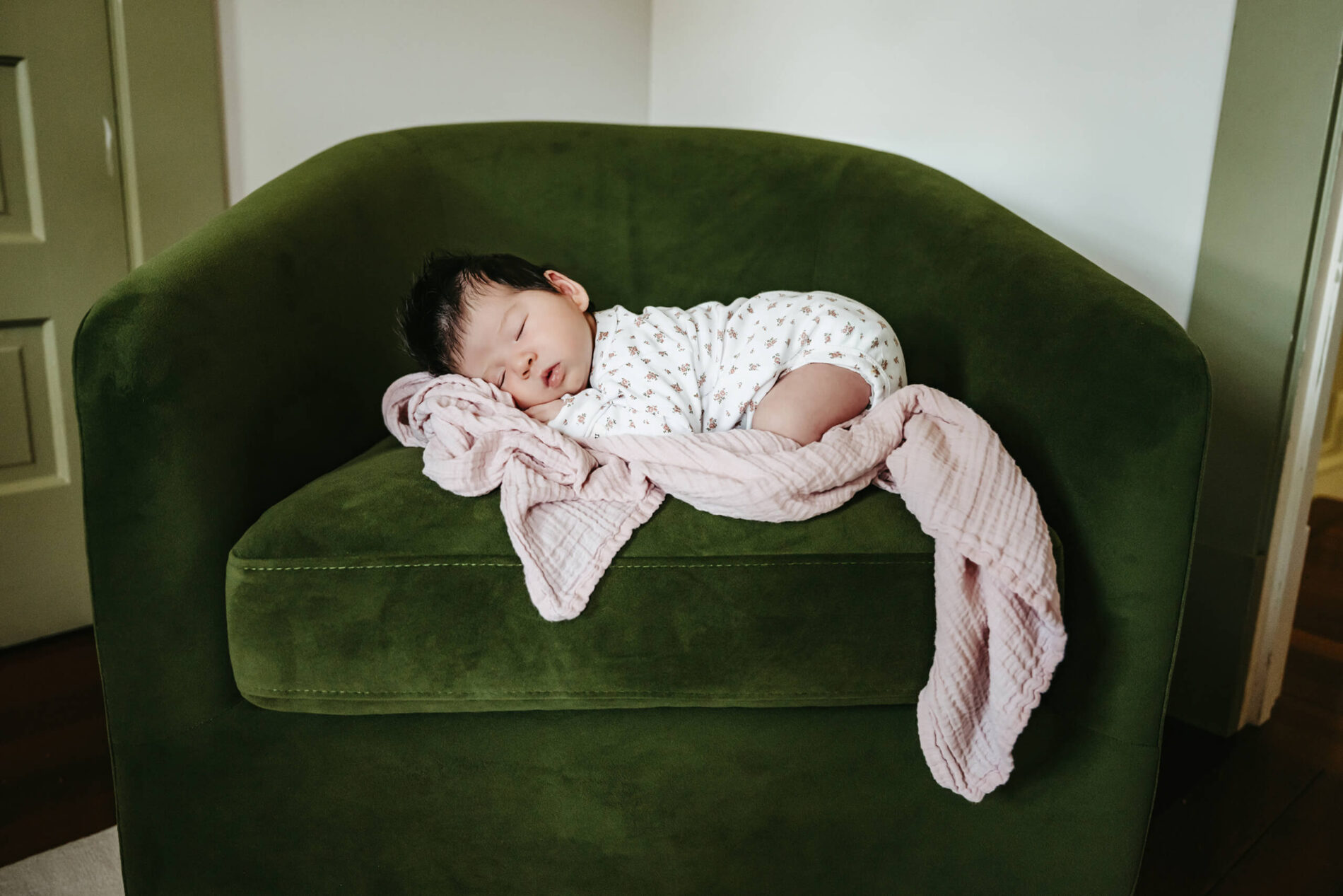 In home newborn photo of a boy sleeping on a chair