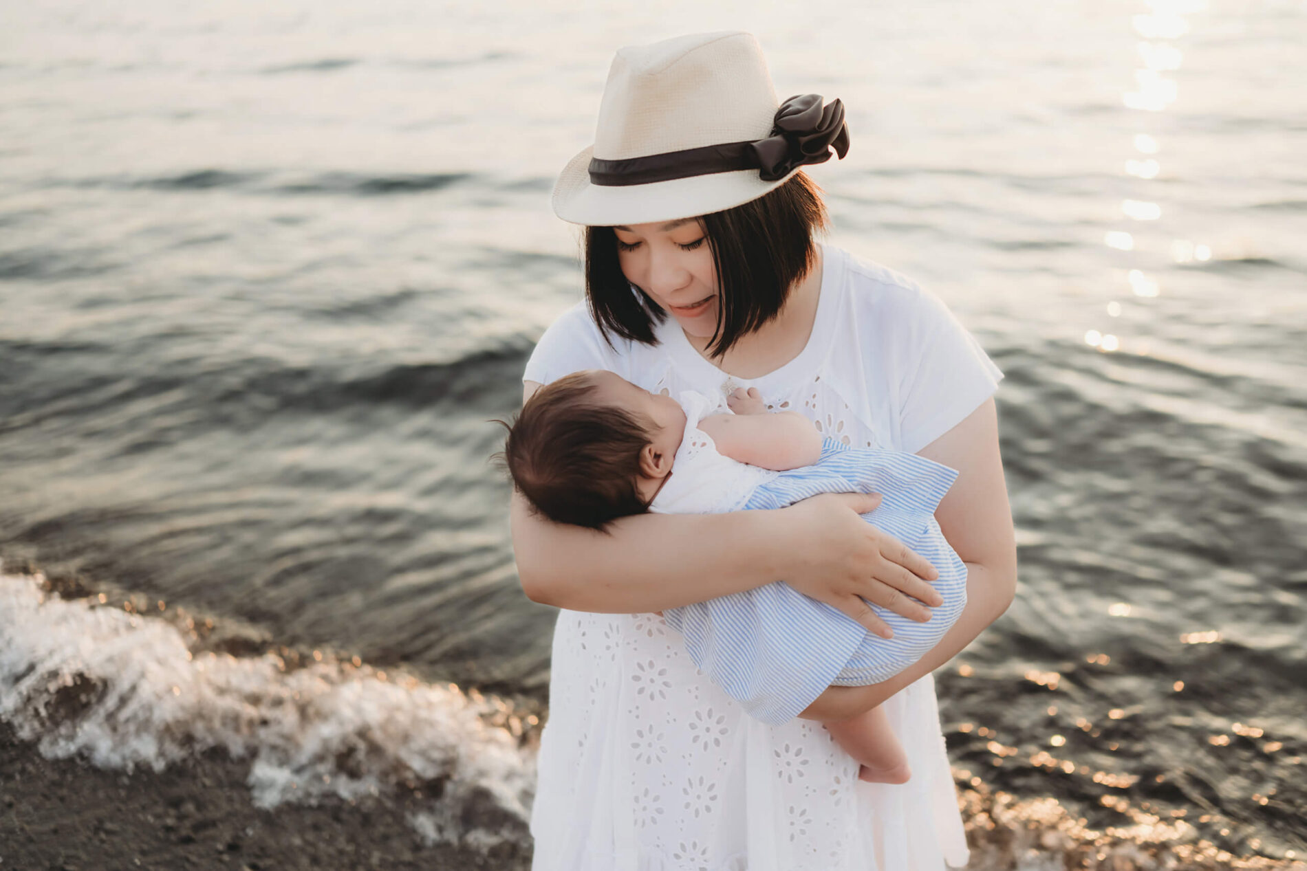 Family photography at Edmonds Beach of mom with baby