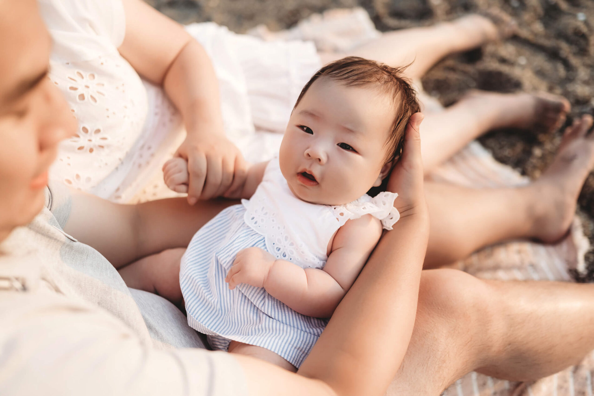 Dad playing with his daughter on Edmonds Beach during family photo session