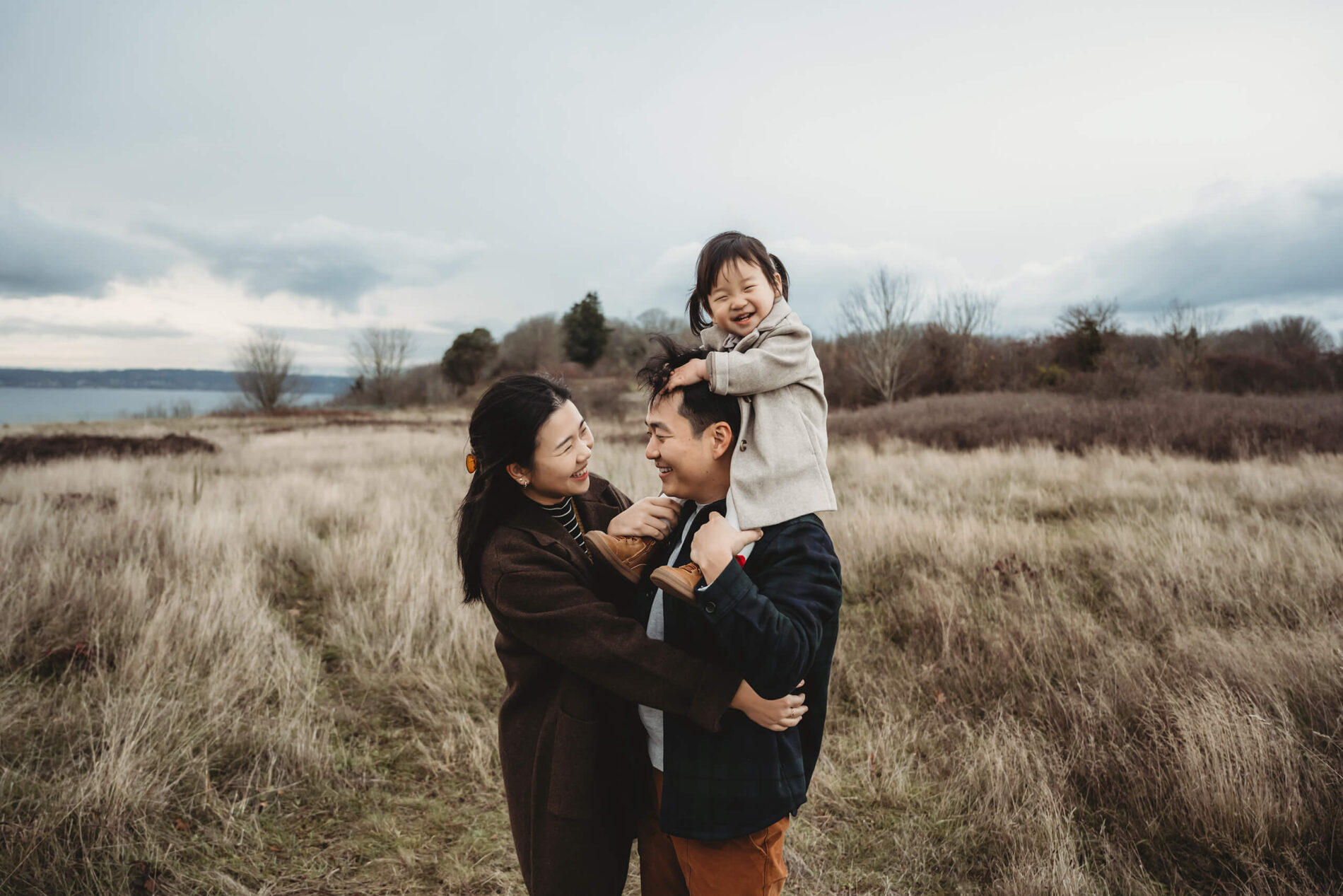 Beautiful moment during a family session at Seattle Discovery Park with views of the Puget Sound