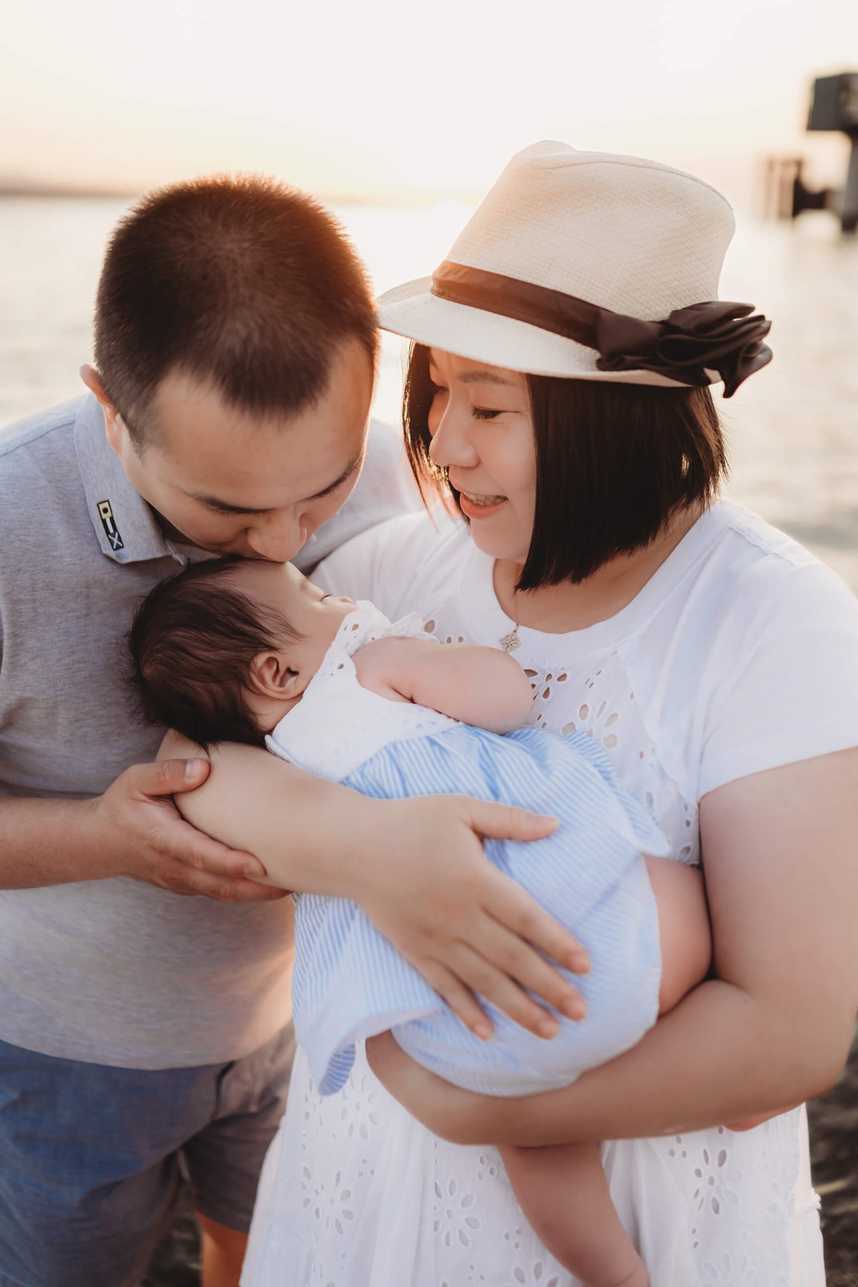 Family of three on a beach during a family photo shoot