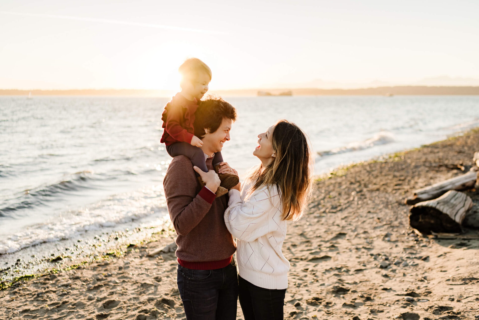 Family being photographed on a beach in Seattle during golden hour