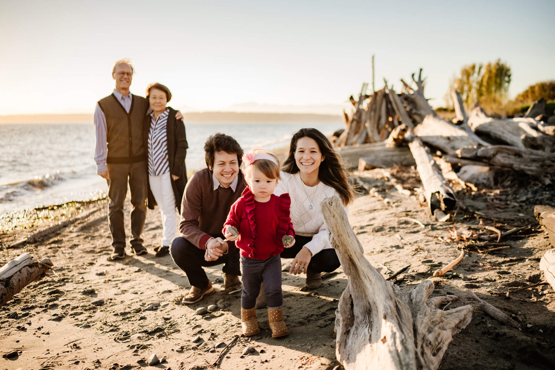 Portrait of a family of three with grandparents at a Seattle beach