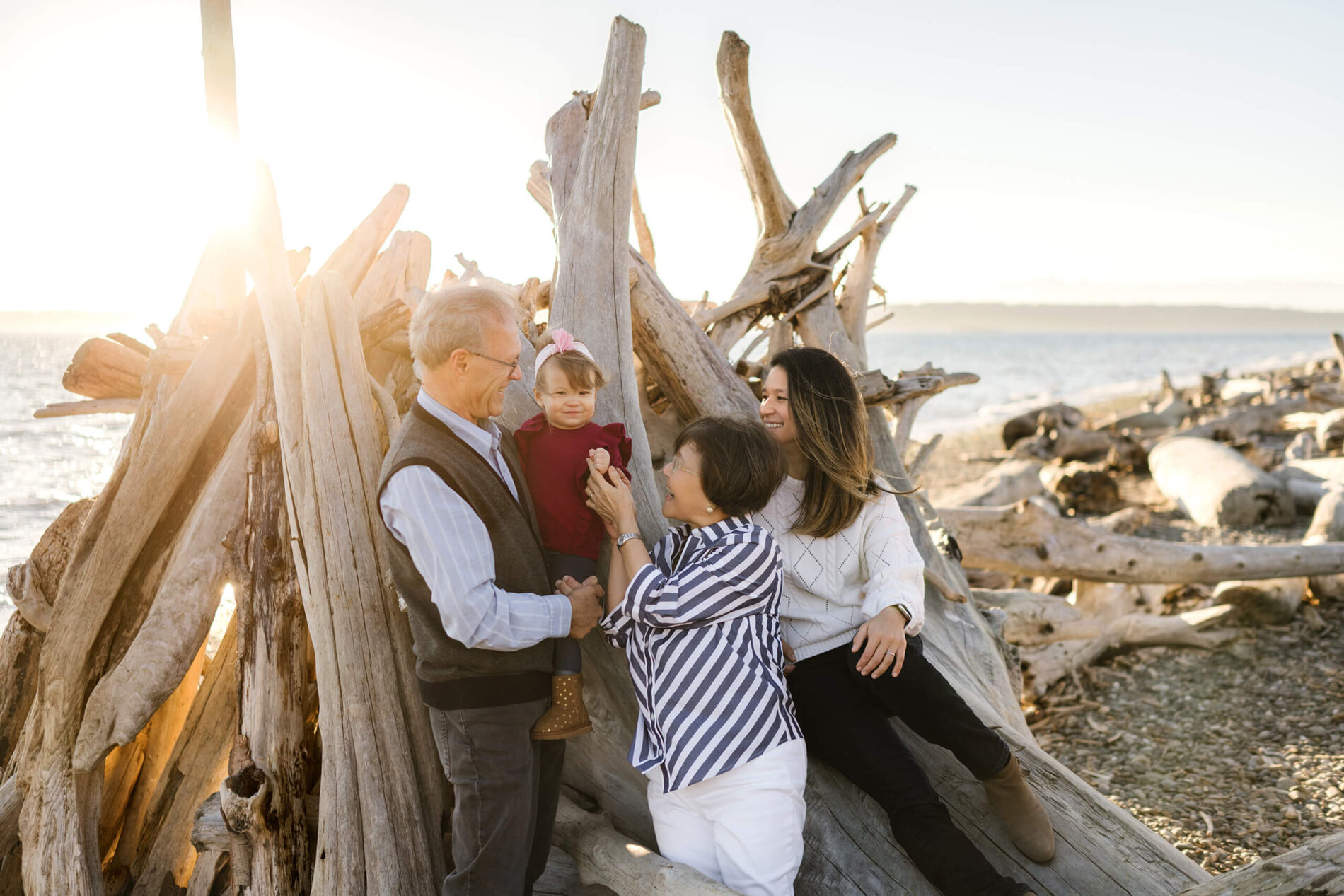 Seattle family photographer working with a family on a beach