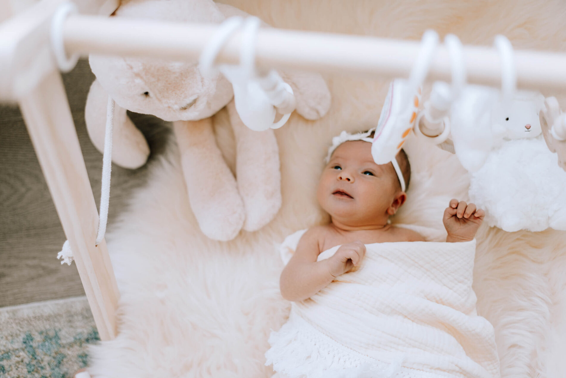 Lifestyle newborn photo of an infant on the floor