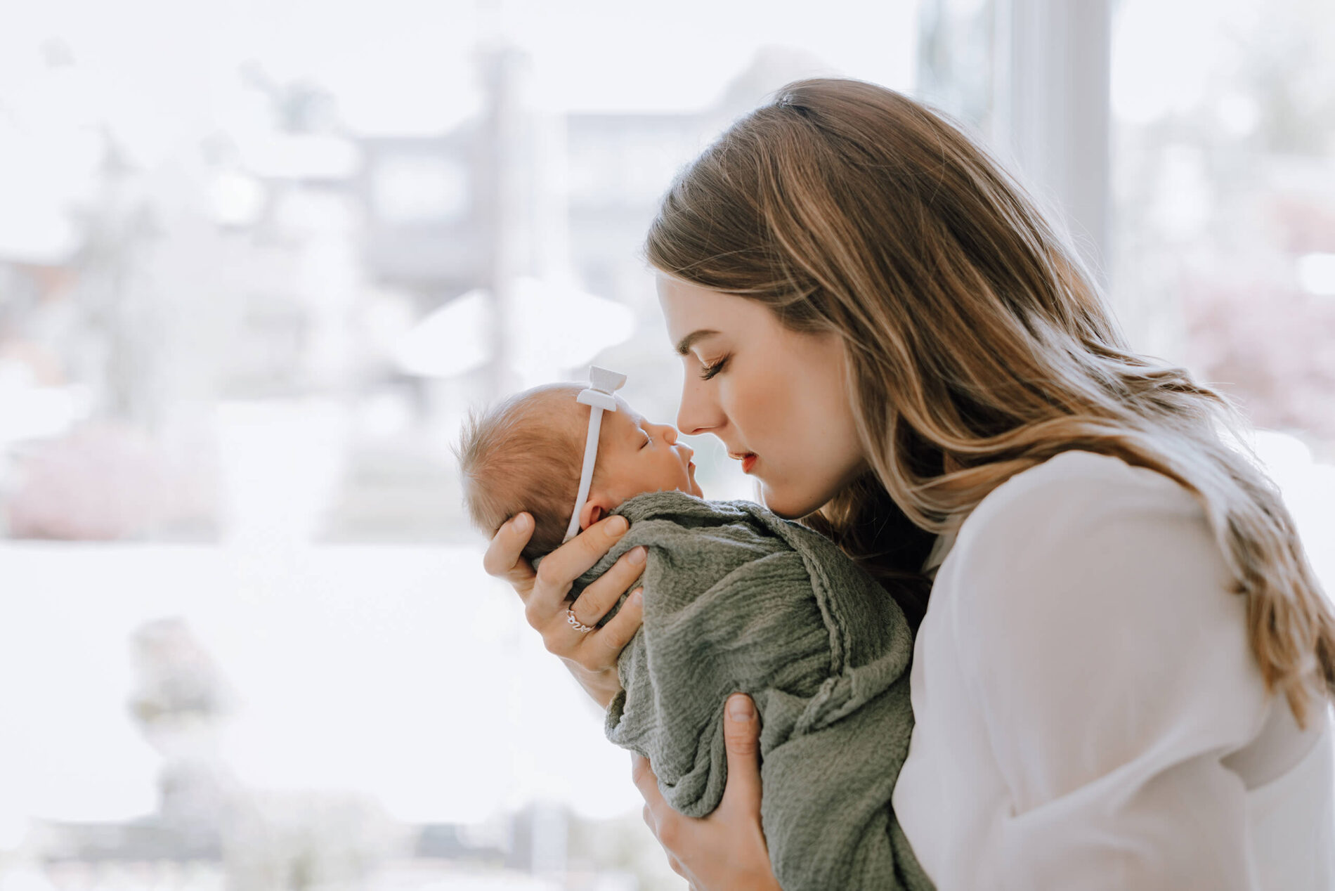 Mom and infant being photographed at home