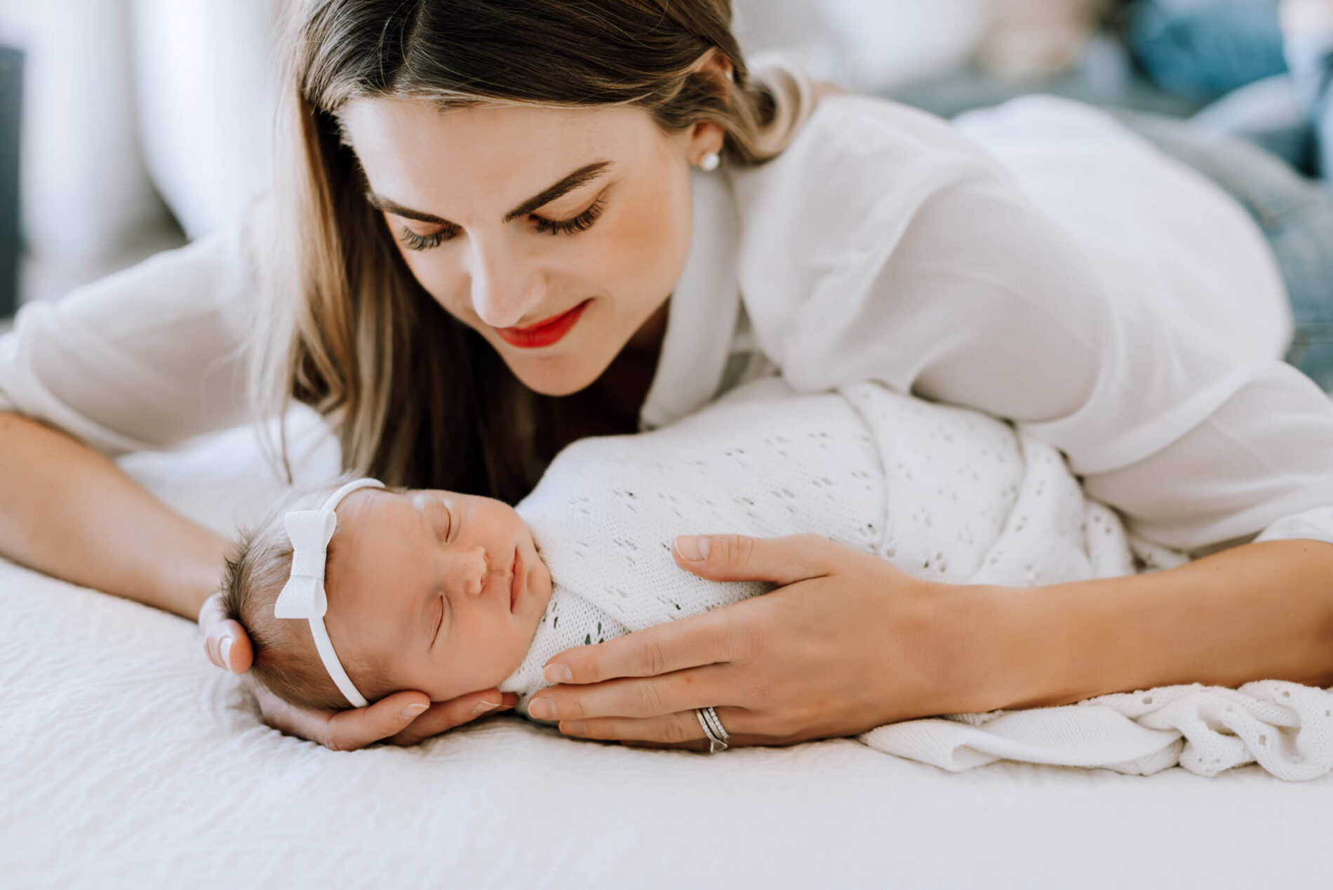 Mom adoring her daughter during lifestyle newborn photoshoot in Seattle