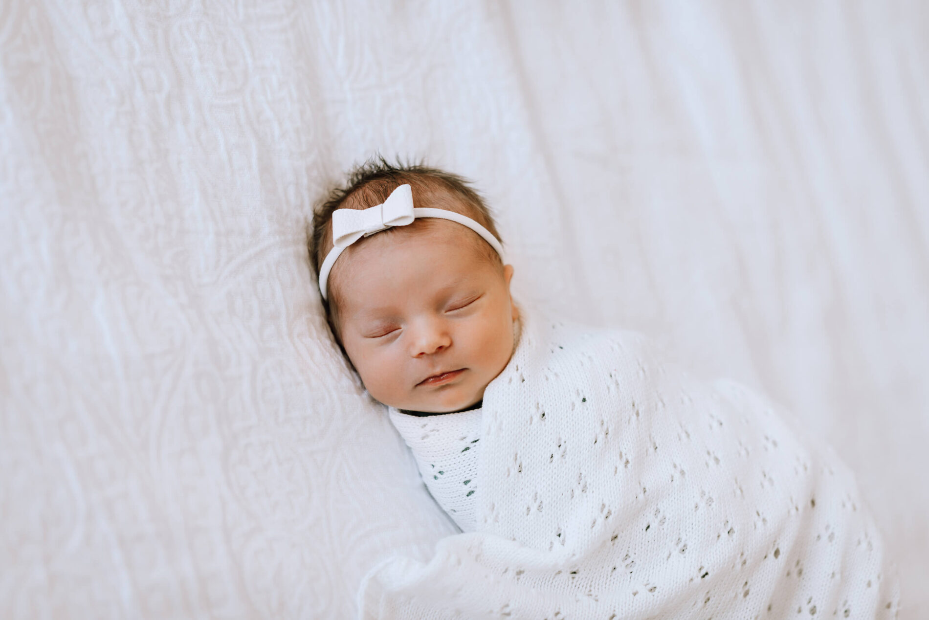 Happy infant during in-home newborn photoshoot in Seattle area