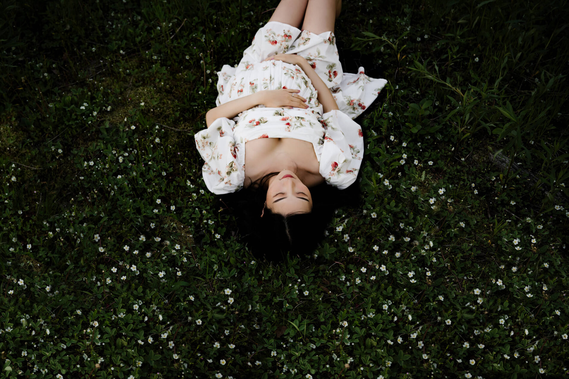 Pregnant woman being posed in a field near Bellevue WA