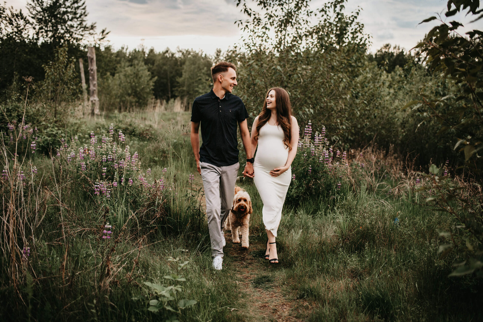 Spring maternity photoshoot with a dog in a field near Bellevue WA