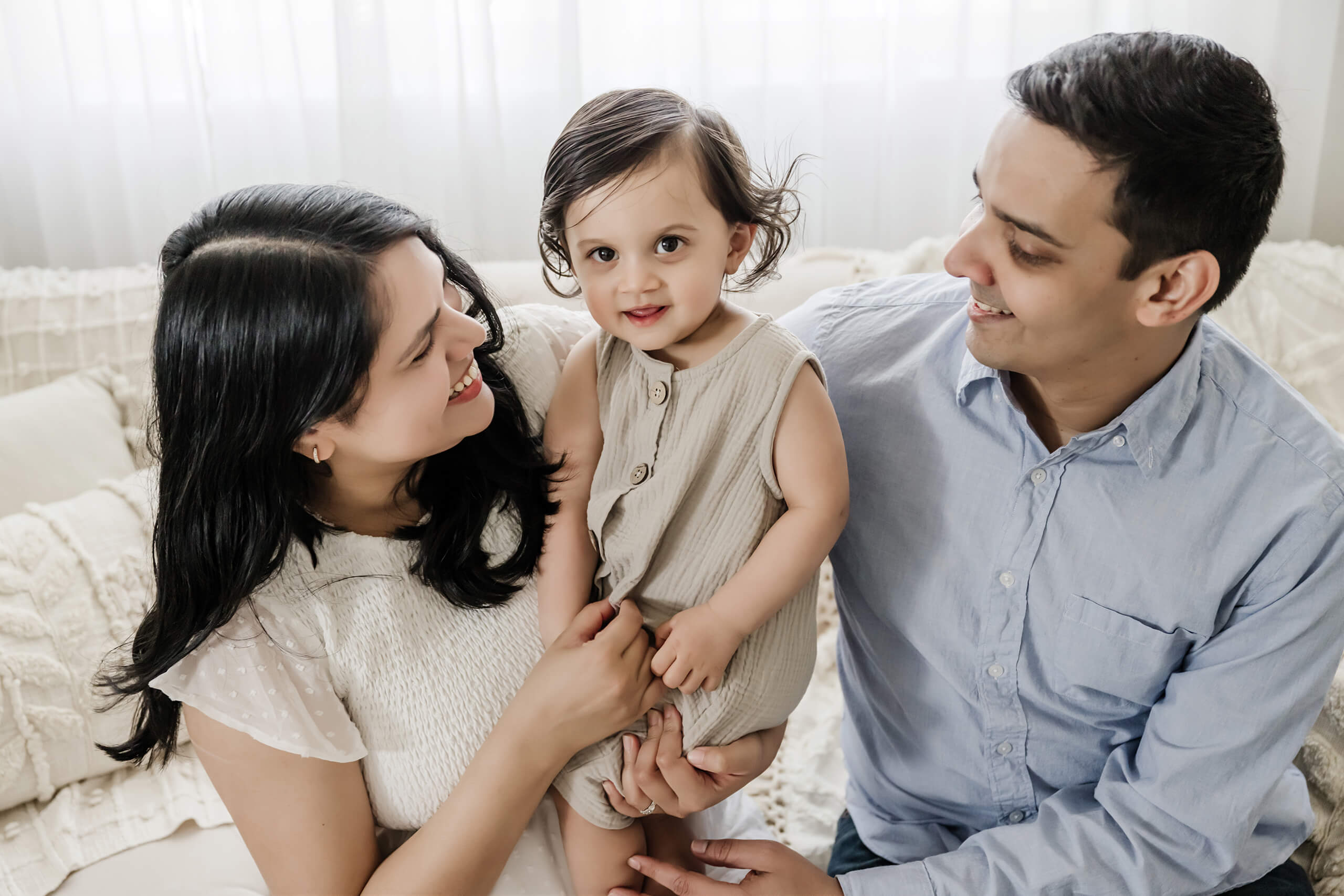 One year photos with parents in the Bellevue area studio