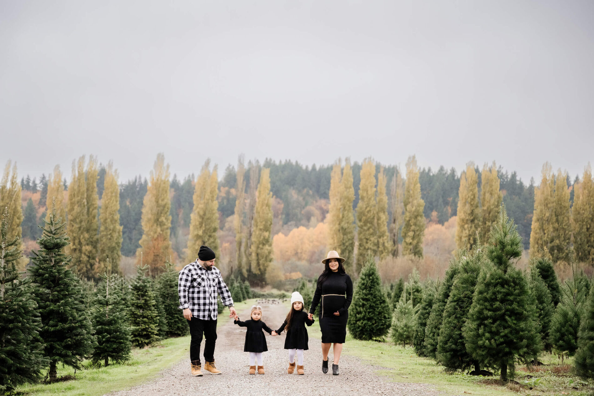 Photo ideas for family of four on a Christmas tree farm