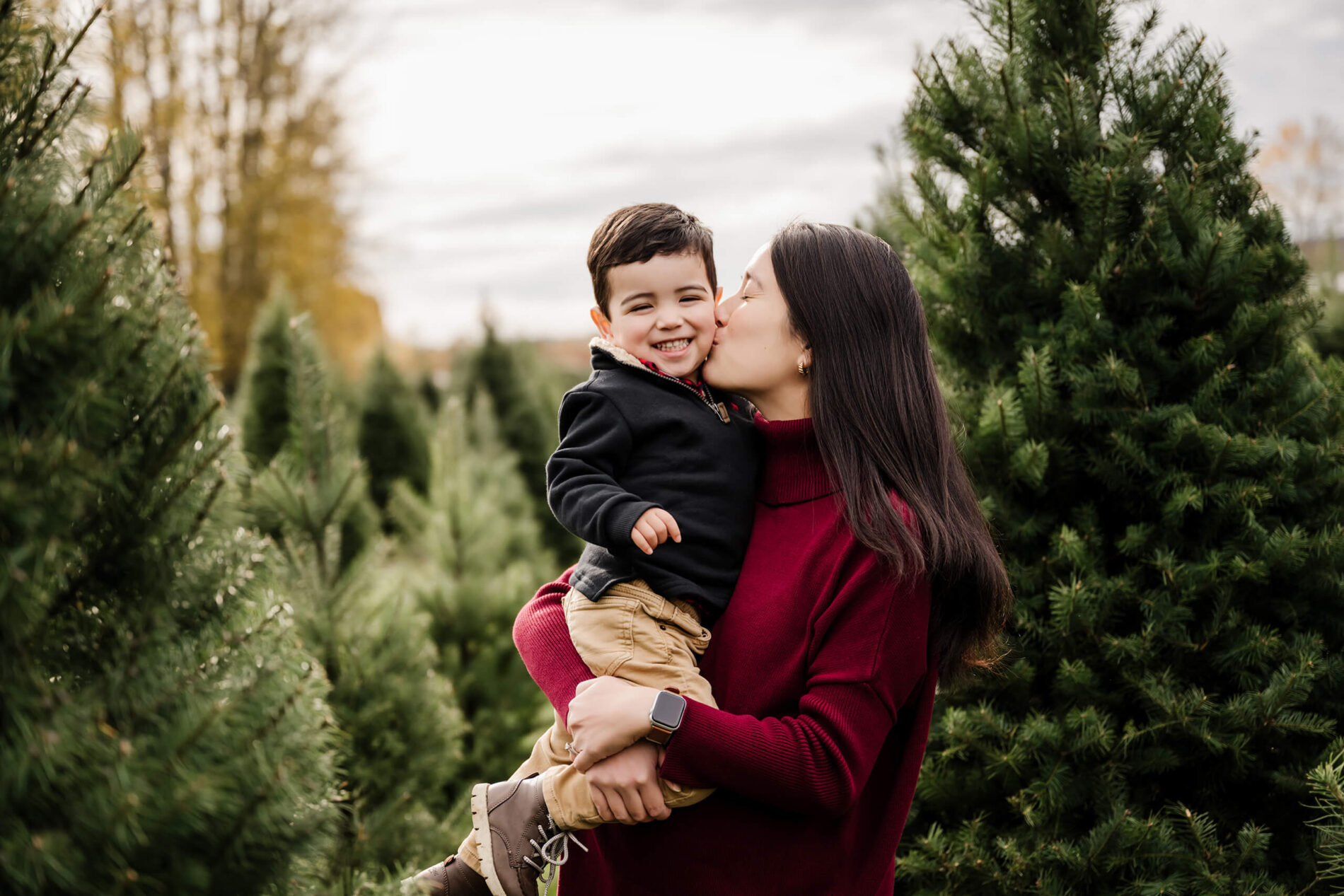 Ideas for posing mom with toddler son on a Christmas tree farm