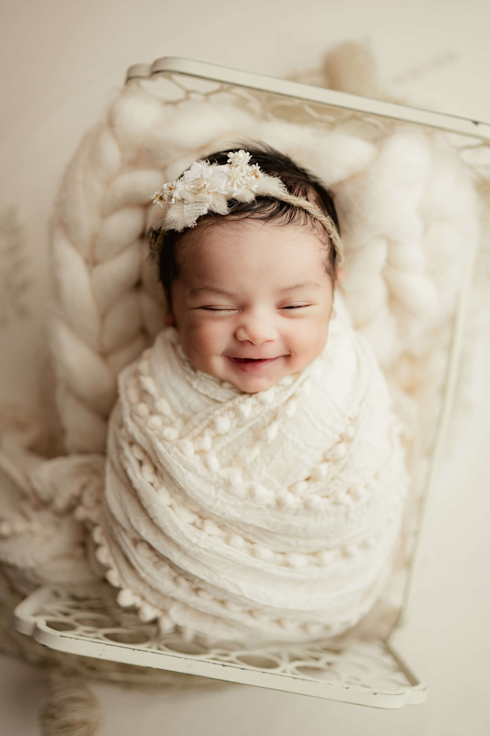 Newborn baby posed during a studio portrait.