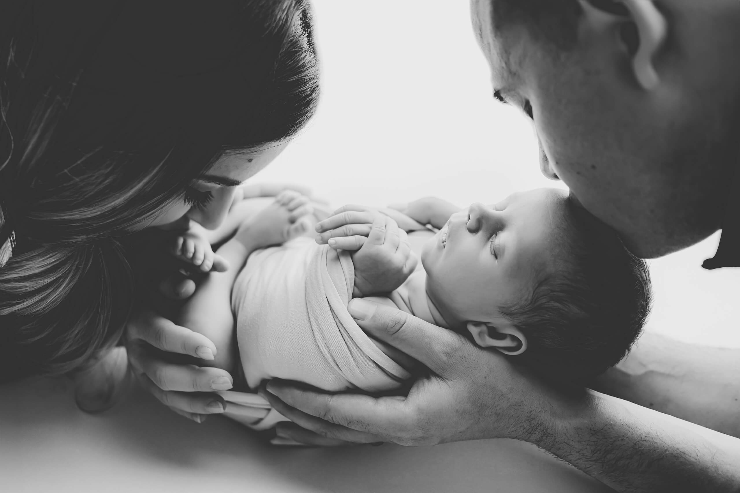 Parents holding their newborn during photoshoot