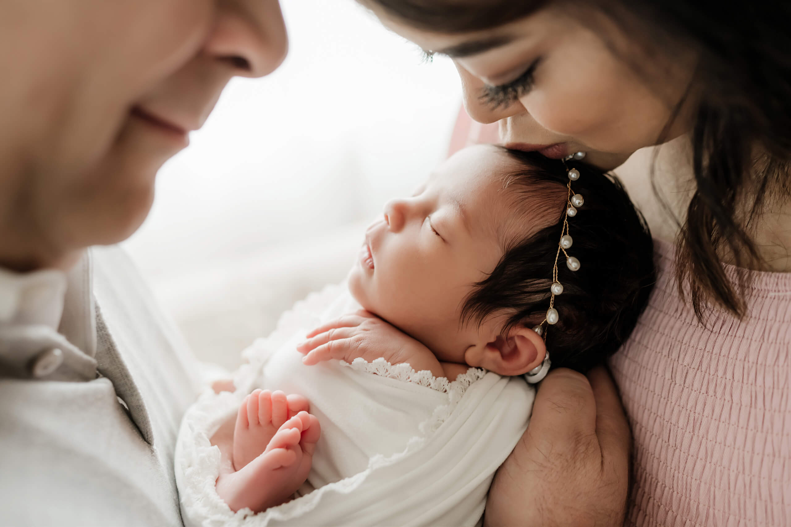 Family during newborn photoshoot in a studio near Sammamish WA
