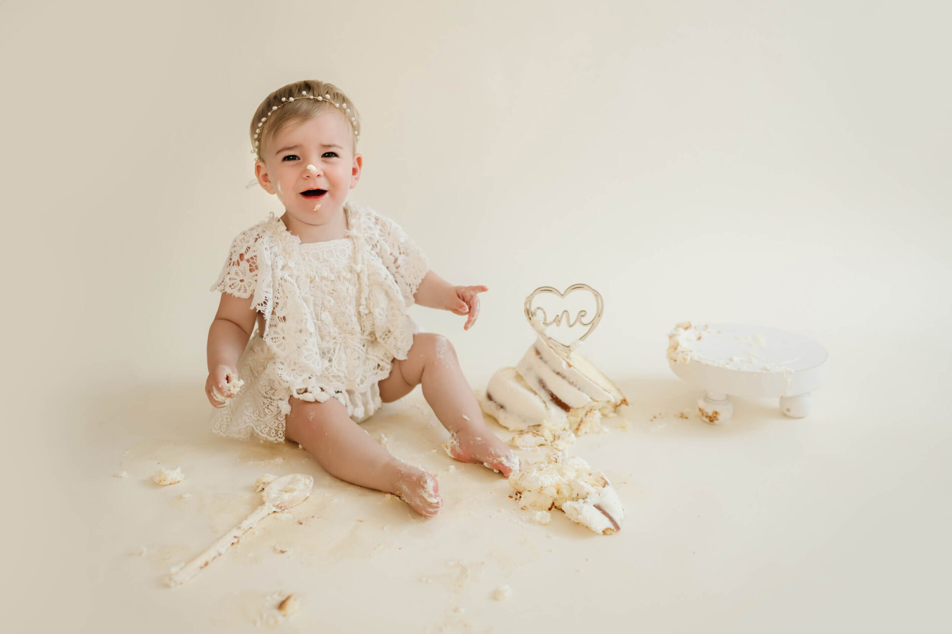 A 1-year-old girl during cake smash photoshoot