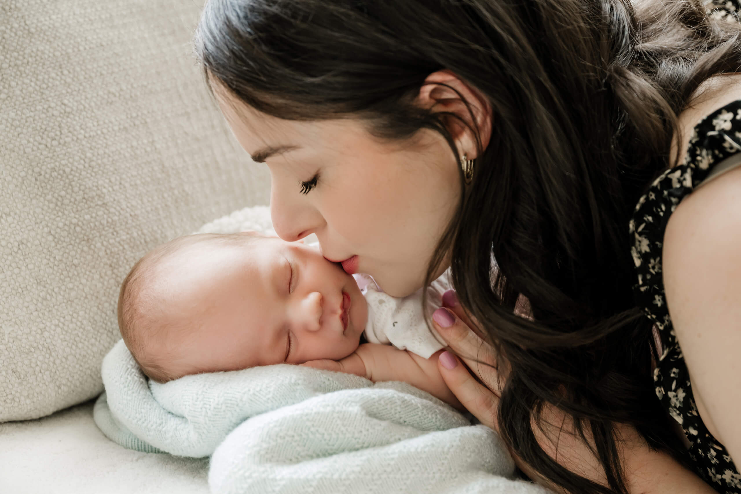 A moment during newborn in-home lifestyle photoshoot in Seattle