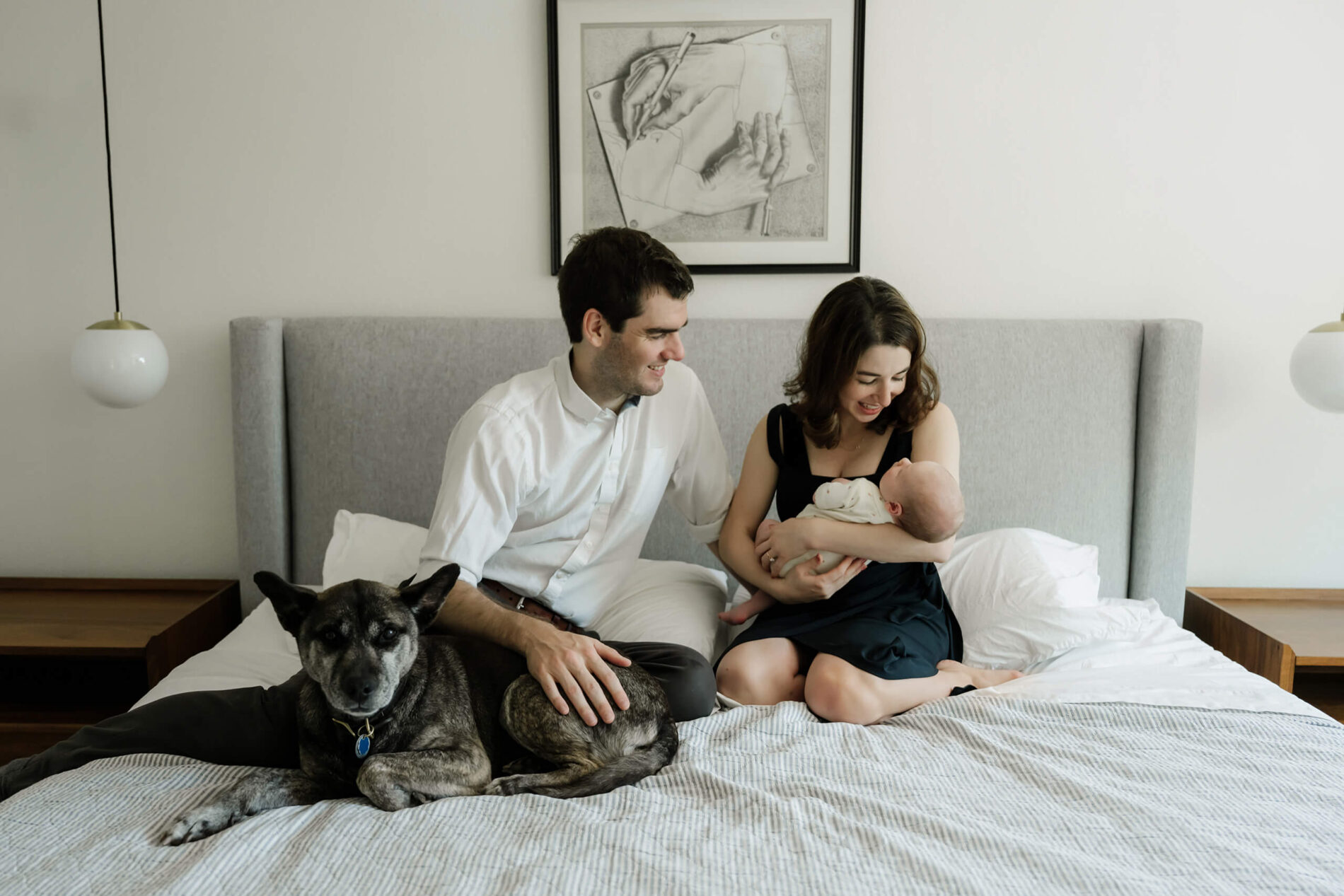 Young parents posing with their baby son during in-home newborn session