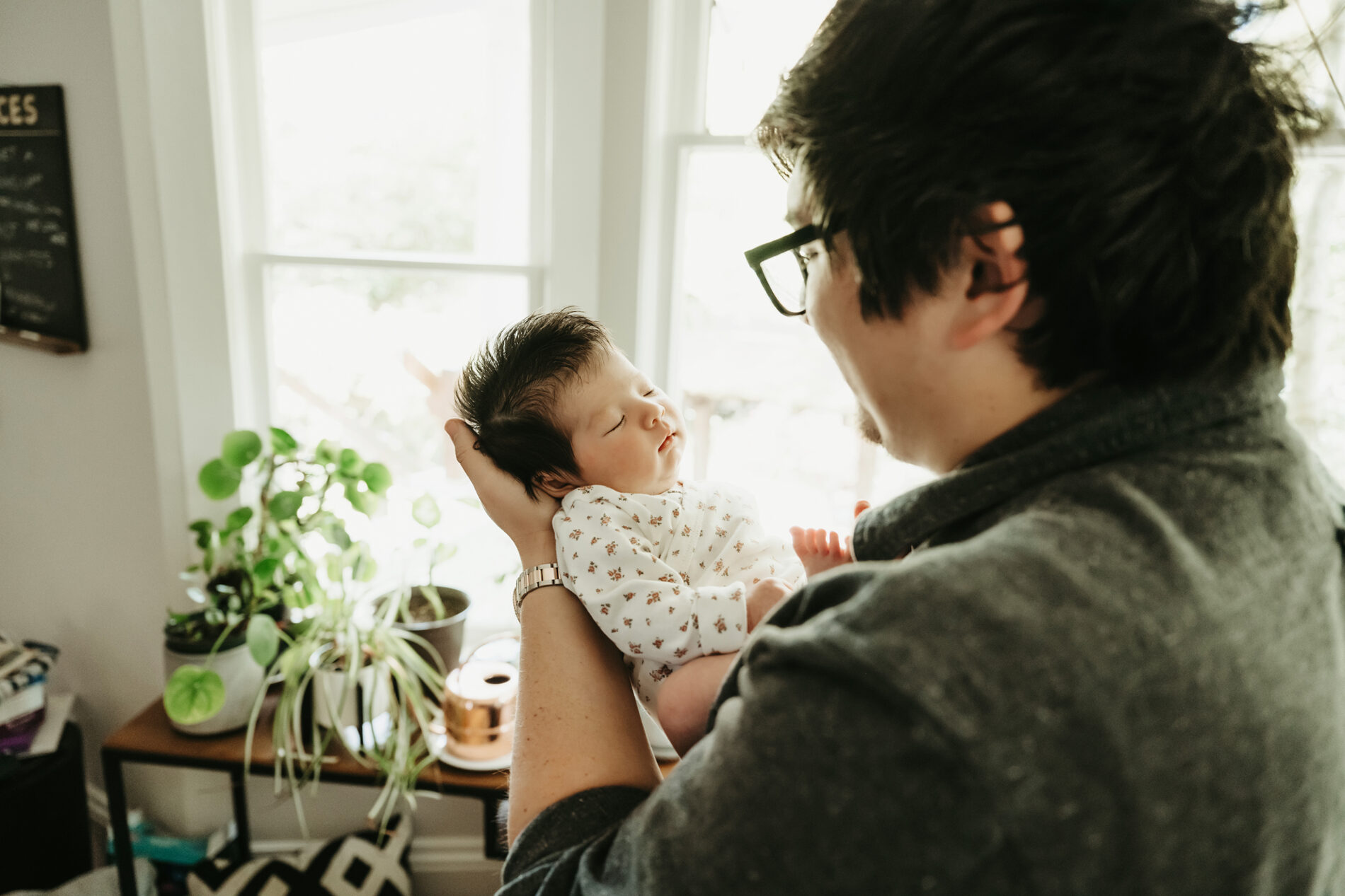 Dad holding his son during newborn in-home session