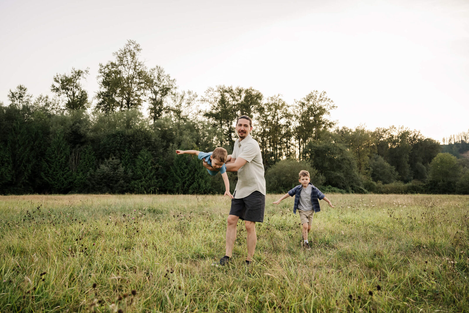 Seattle family photographer doing a family session in a field during summer